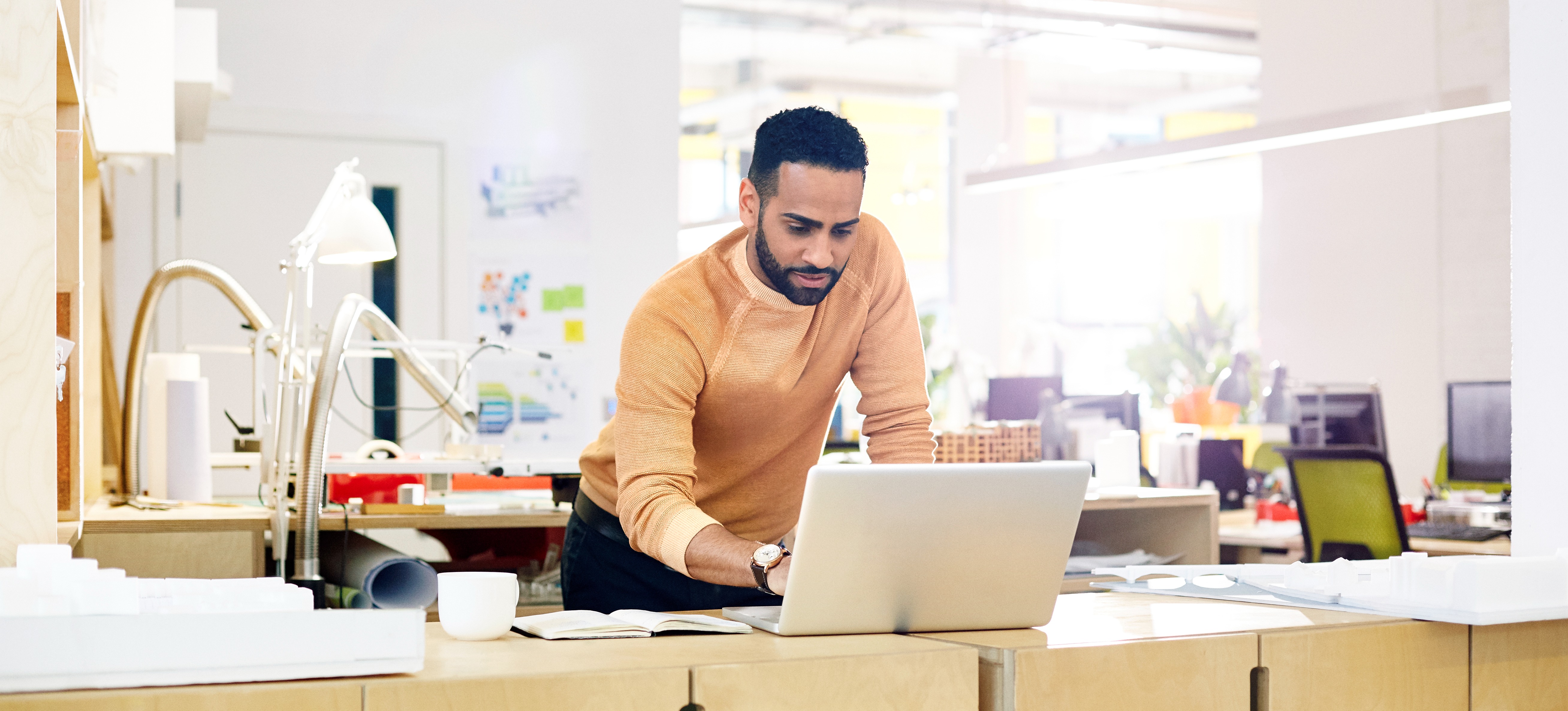 [Feature Image] A computing professional studies on a laptop as they prepare for cloud architect certification to advance their career.

