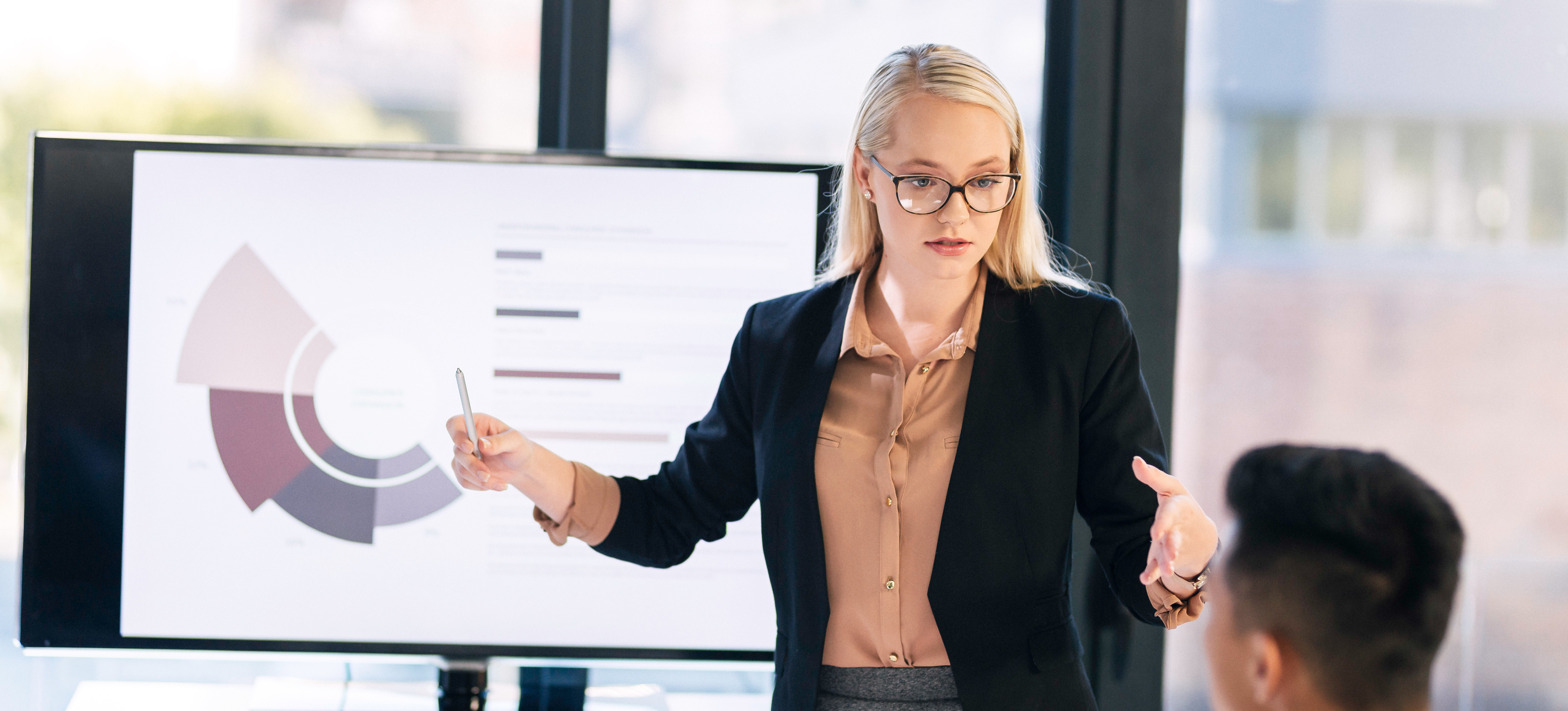 [Featured Image] A project manager presenting data analysis during a meeting in a professional environment, discussing key aspects of model evaluation techniques and performance metrics in machine learning.
