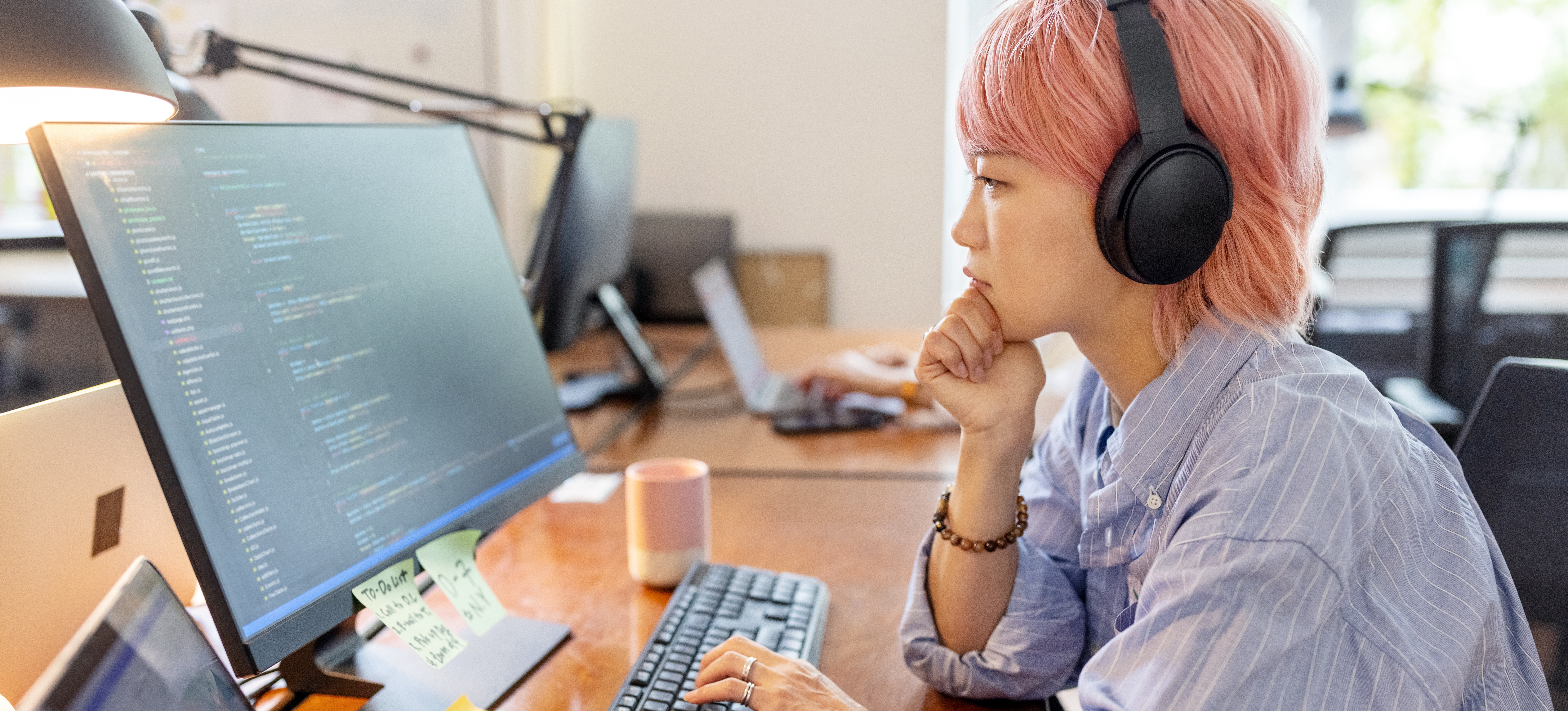 [Featured Image]  A young businesswoman is coding on computer while building her skill set to become an nlp engineer.