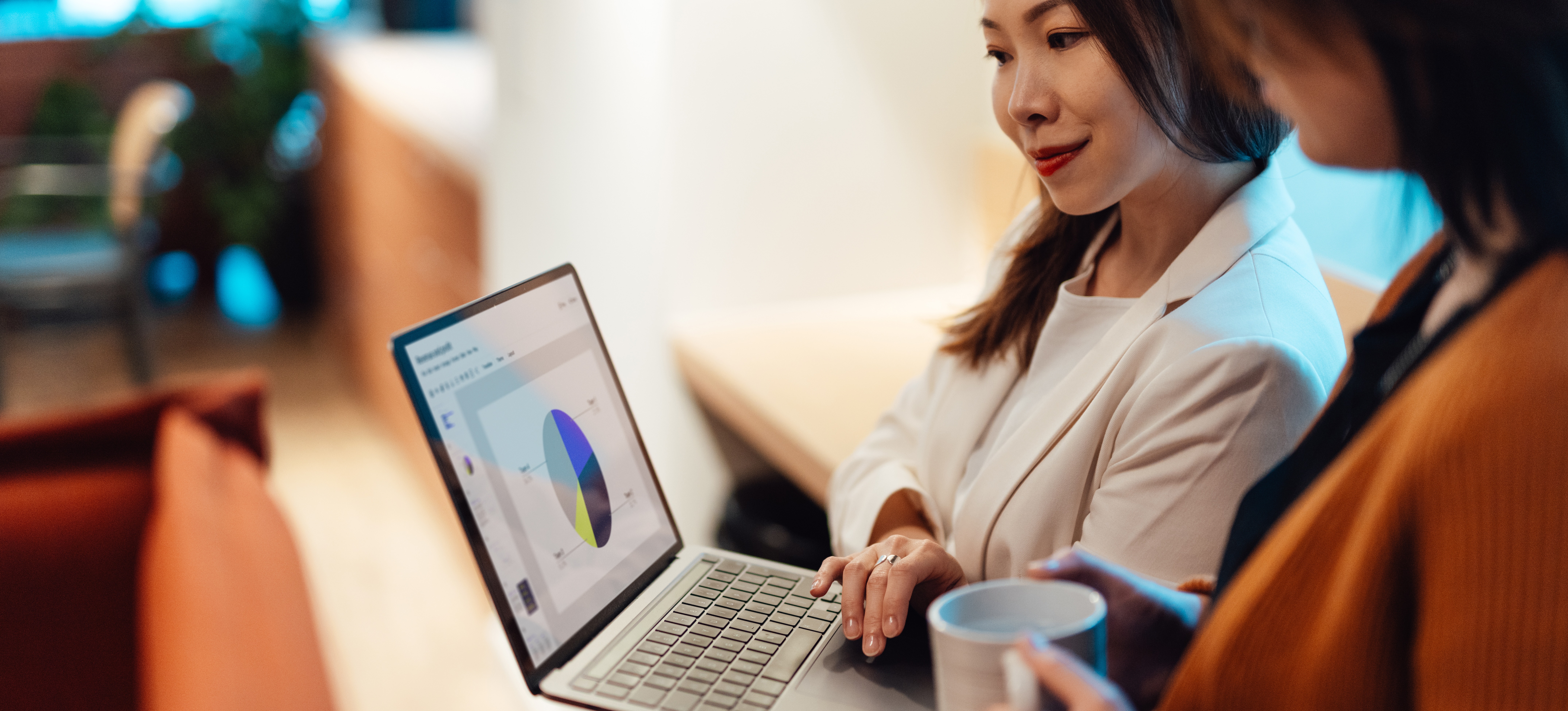 [Feature Image] Two data professionals review their data preprocessing steps together on a laptop to make sure they didn’t miss anything important. 
