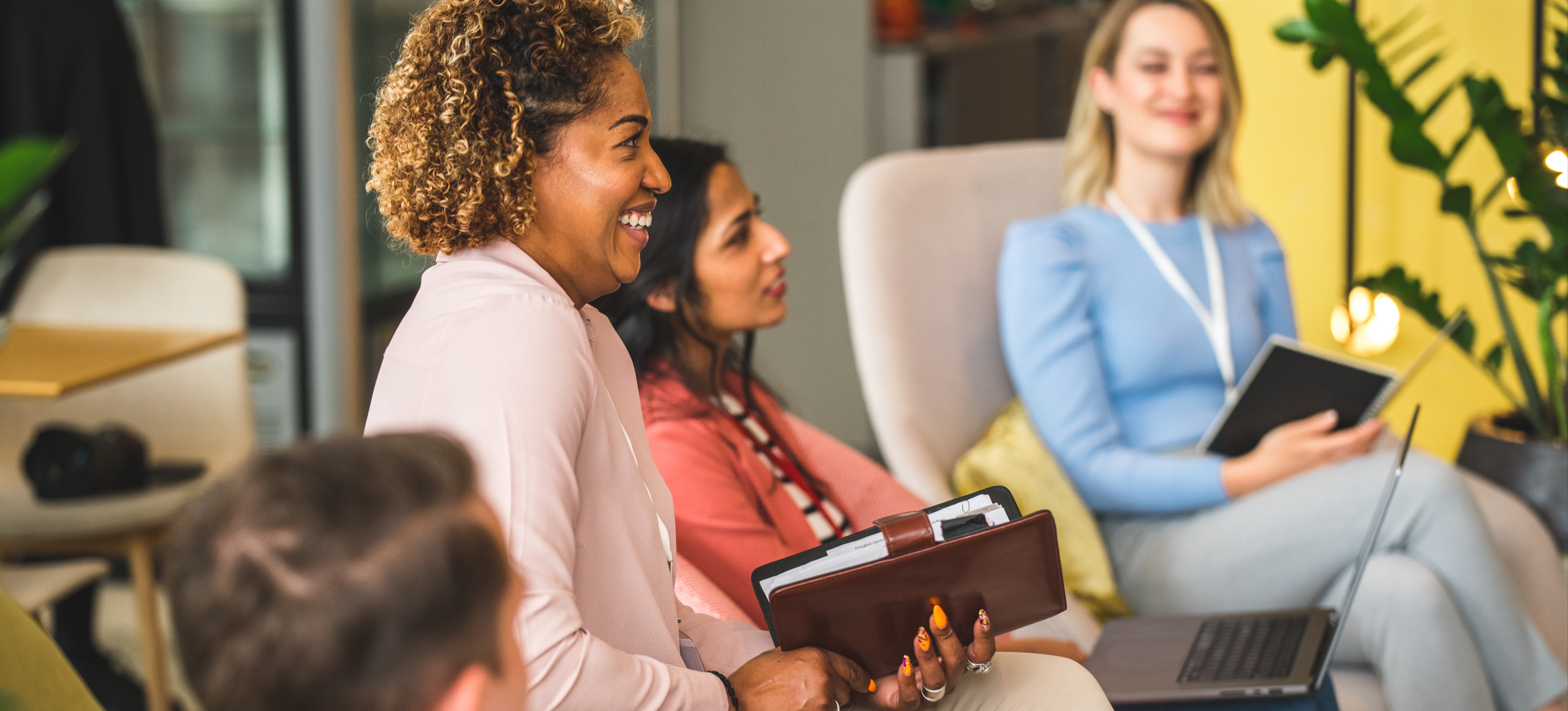 [Featured Image] A group of business people sit in a casual workshop setting as they learn business development skills.

