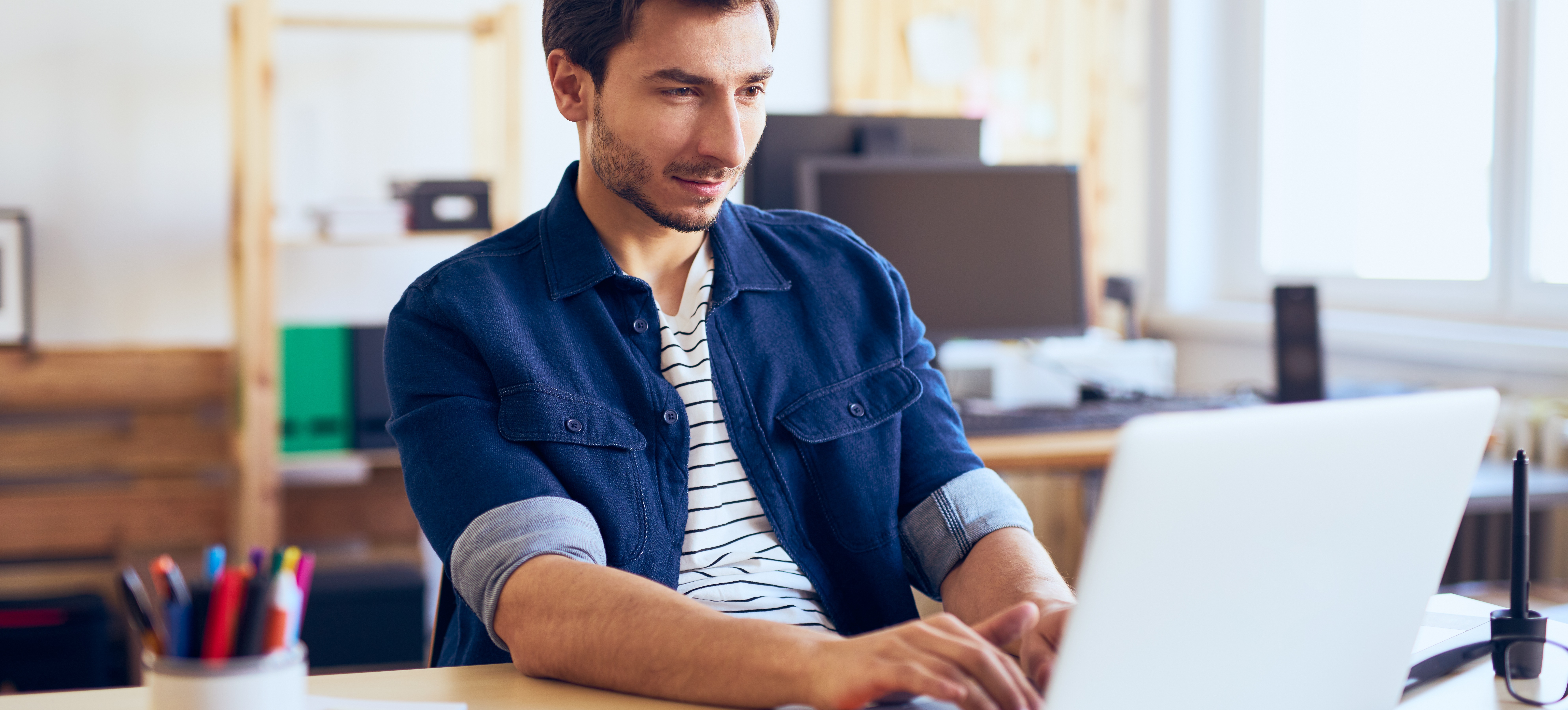 [Featured Image] A man interested in programming learns the R language on his laptop at home.
