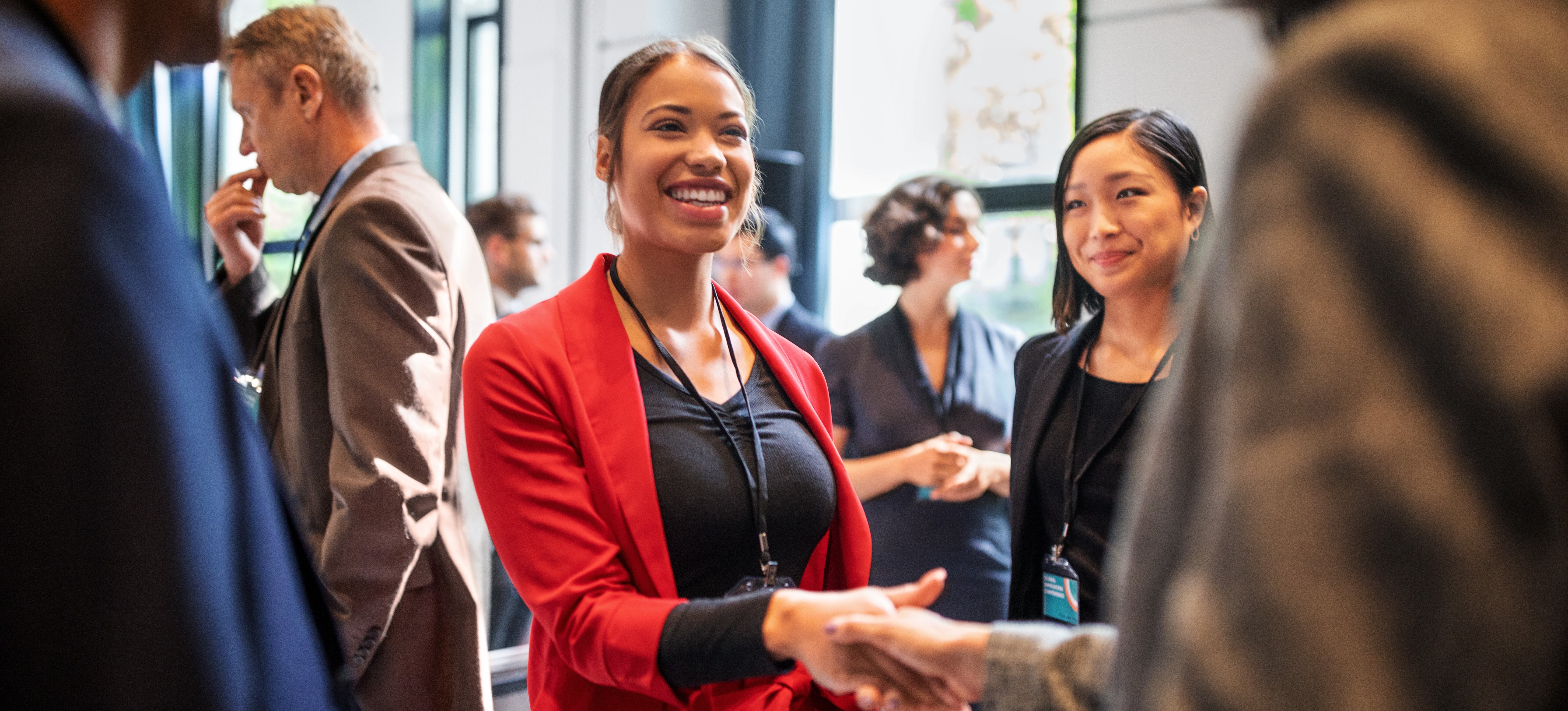 [Featured image] A smiling person in a group of colleagues discusses talent mobility.