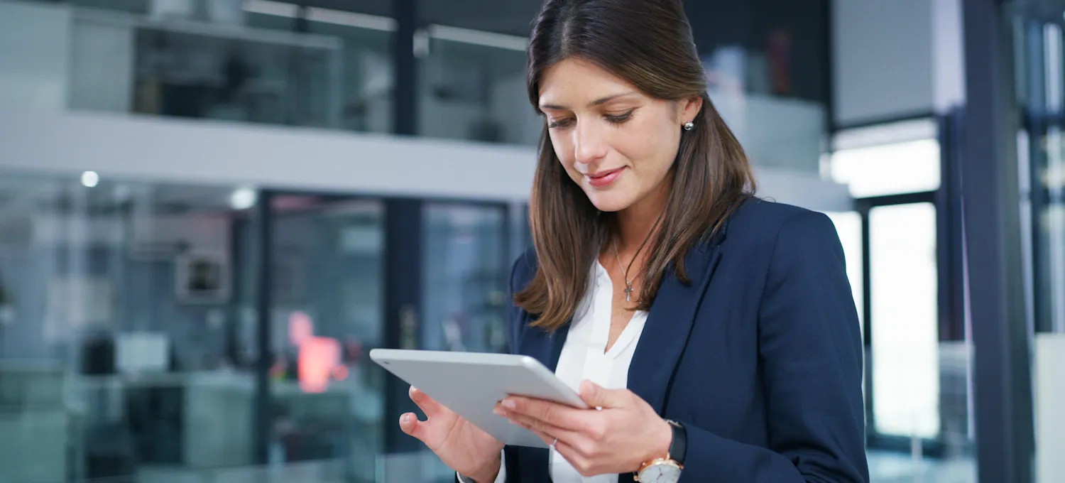 [Featured Image] A business person uses MDM software on their tablet.