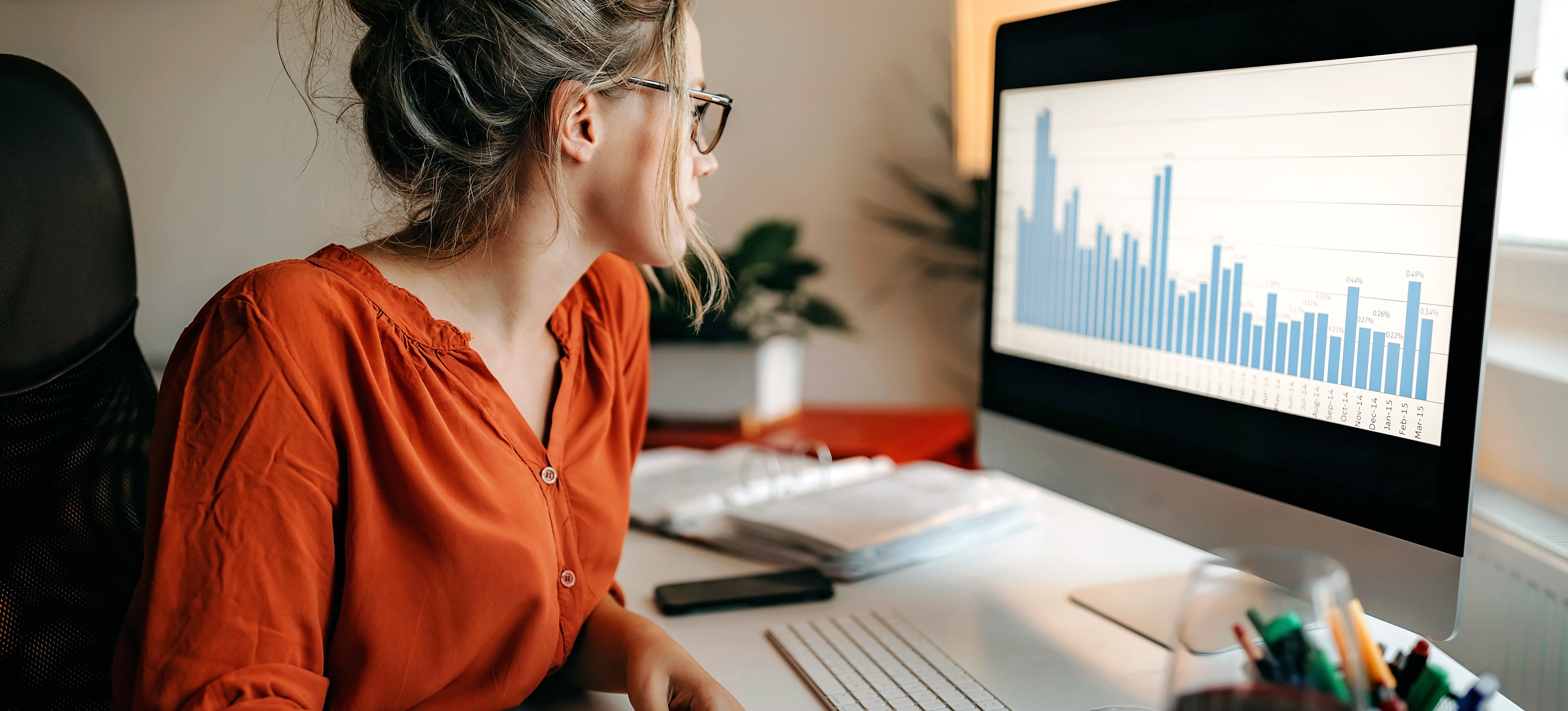 [Featured Image] An operations research analyst consults a data visualization to better understand the decisions their company is making. 
