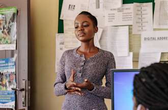 [Featured Image]:  Public Health manager discussing sustainability concepts with the team.