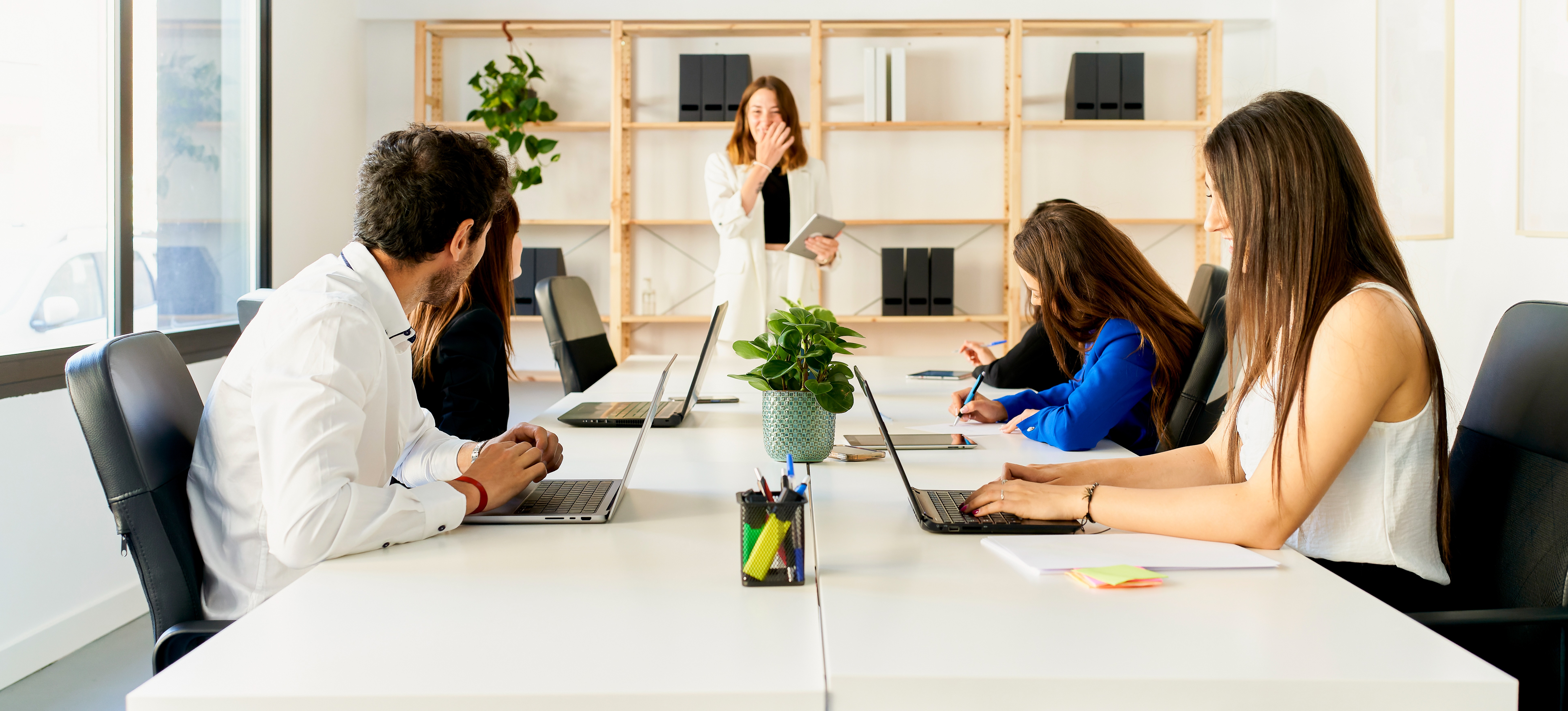 [Featured Image] A group of cybersecurity professionals meet in a conference room to discuss creating a new penetration testing plan.
