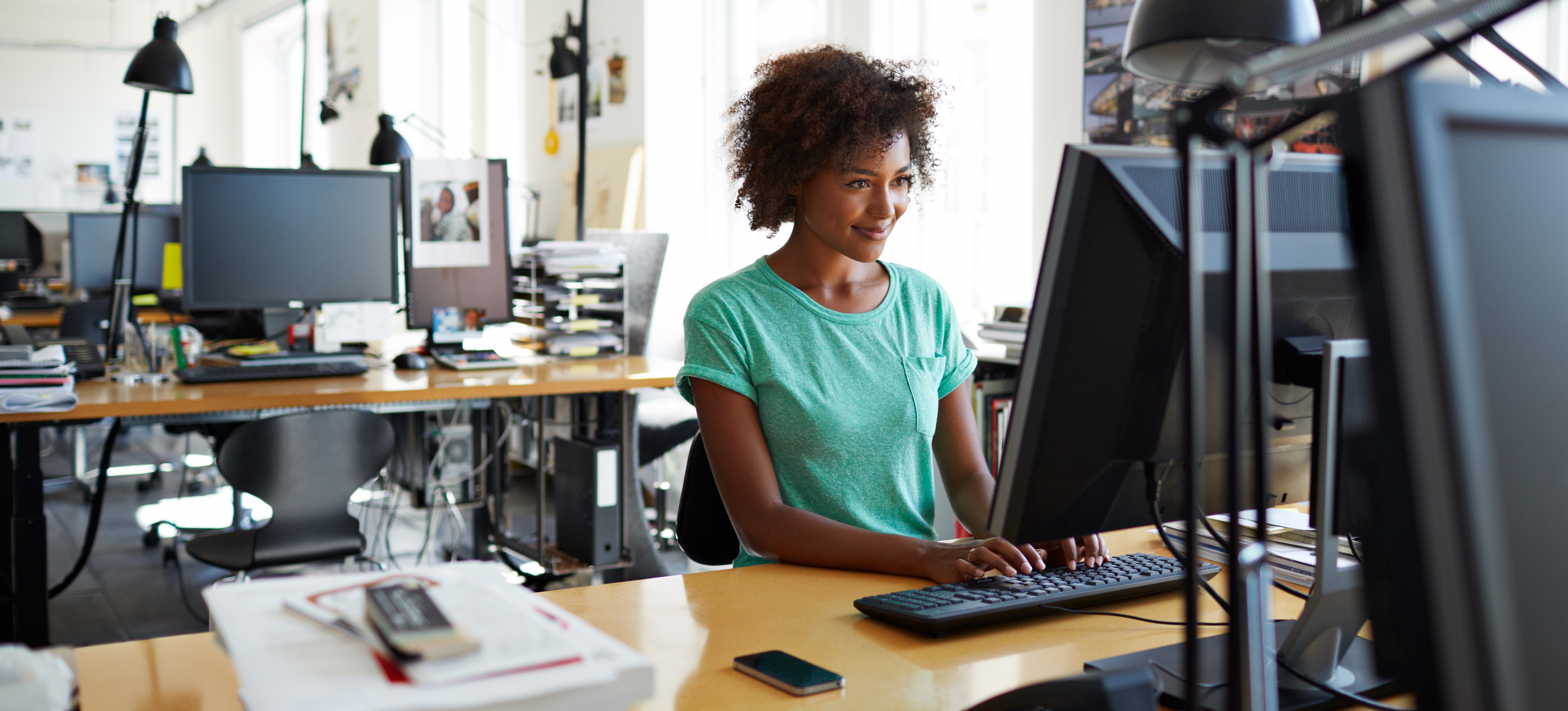 [Featured Image] A skilled email marketer is at her computer tailoring an email campaign to individual preferences for their customers.
