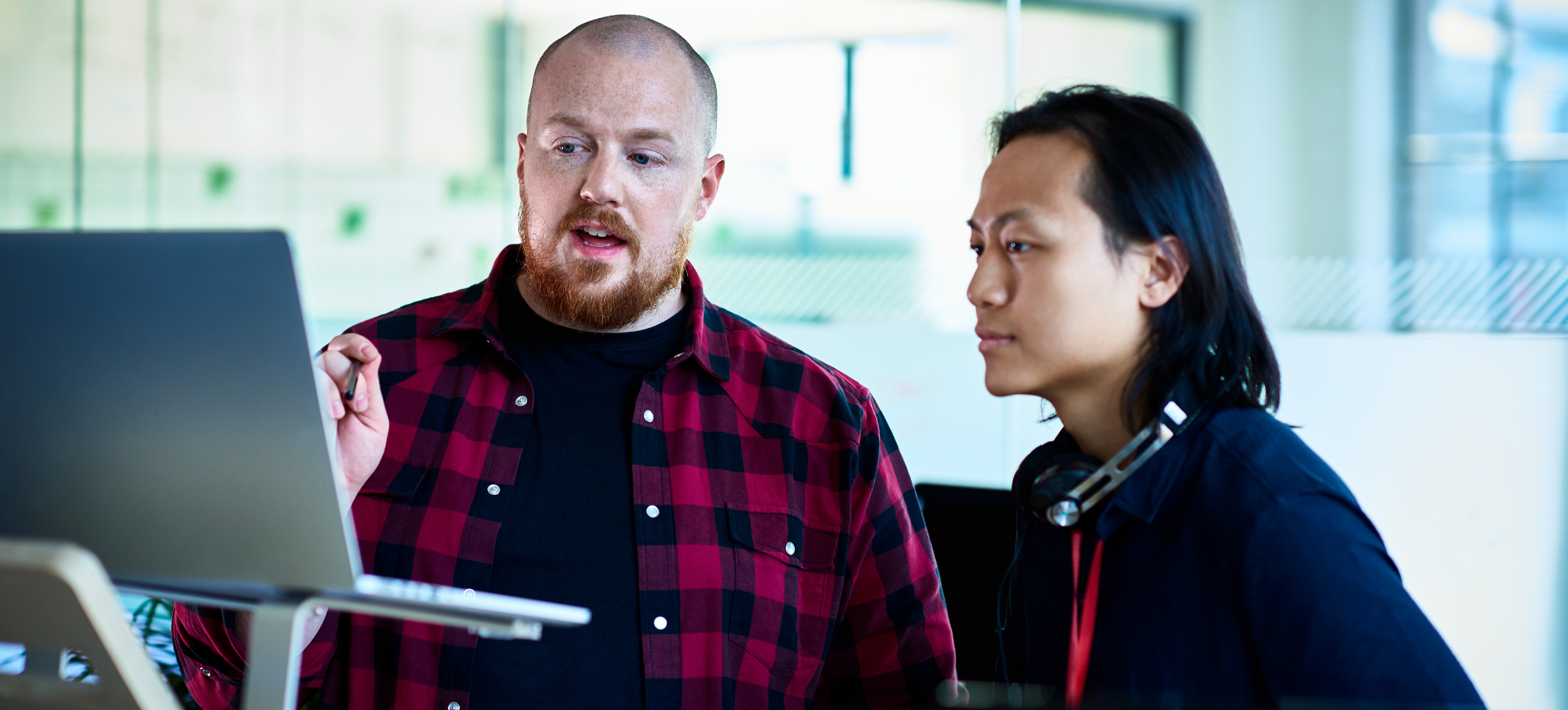 [Featured image] Machine learning professionals discussing the difference between SVM and decision trees in an office.