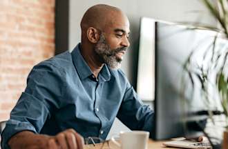 [Featured Image] A data scientist sits at his computer and uses a box plot to compare sets of data.