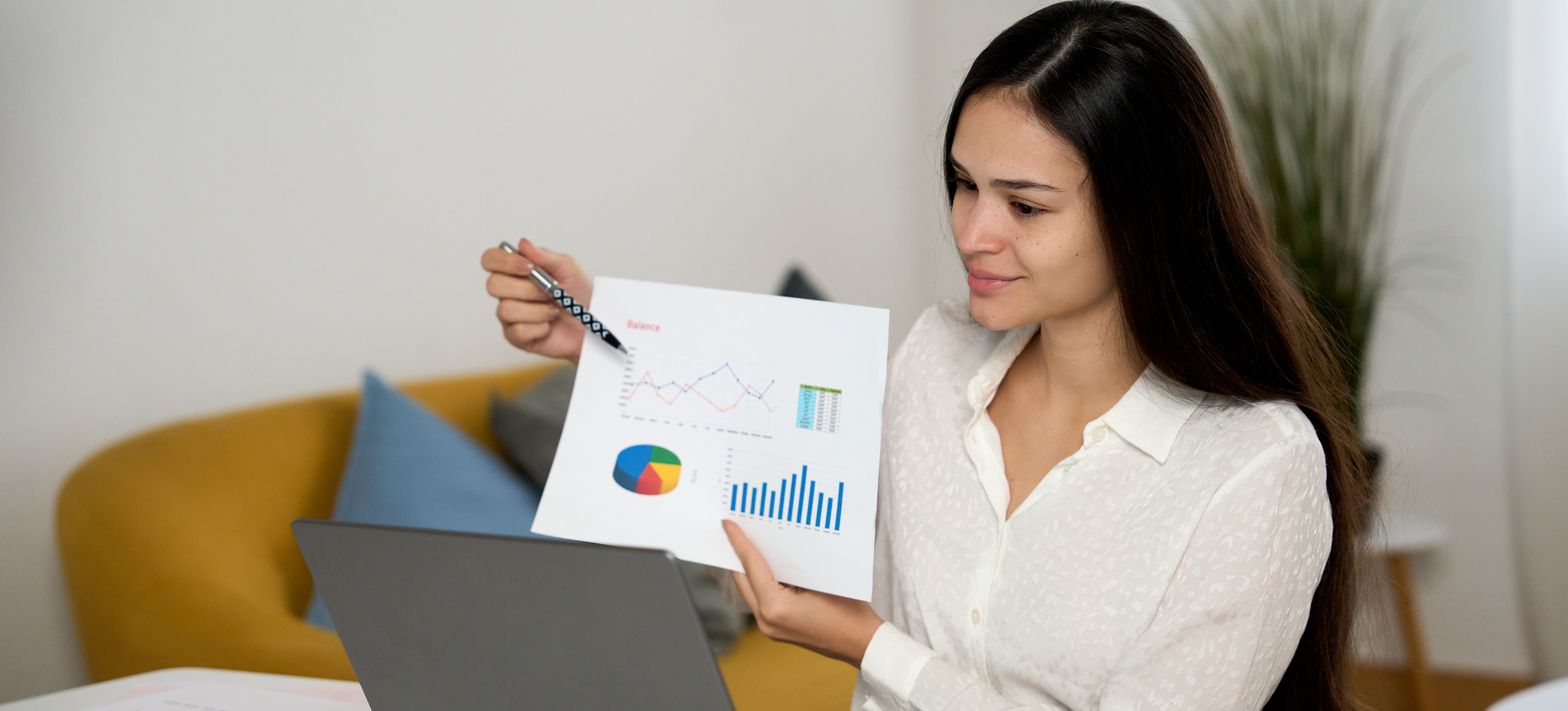 [Featured Image] A businesswoman shows graphs and data to colleagues on a video call to help them understand the different types of data involved in their project.