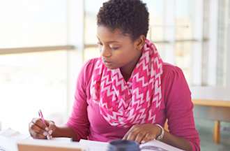 [Featured Image] A learner works in a well-lit room with an open laptop and books on the desk as they study database cardinality and its various uses. 
