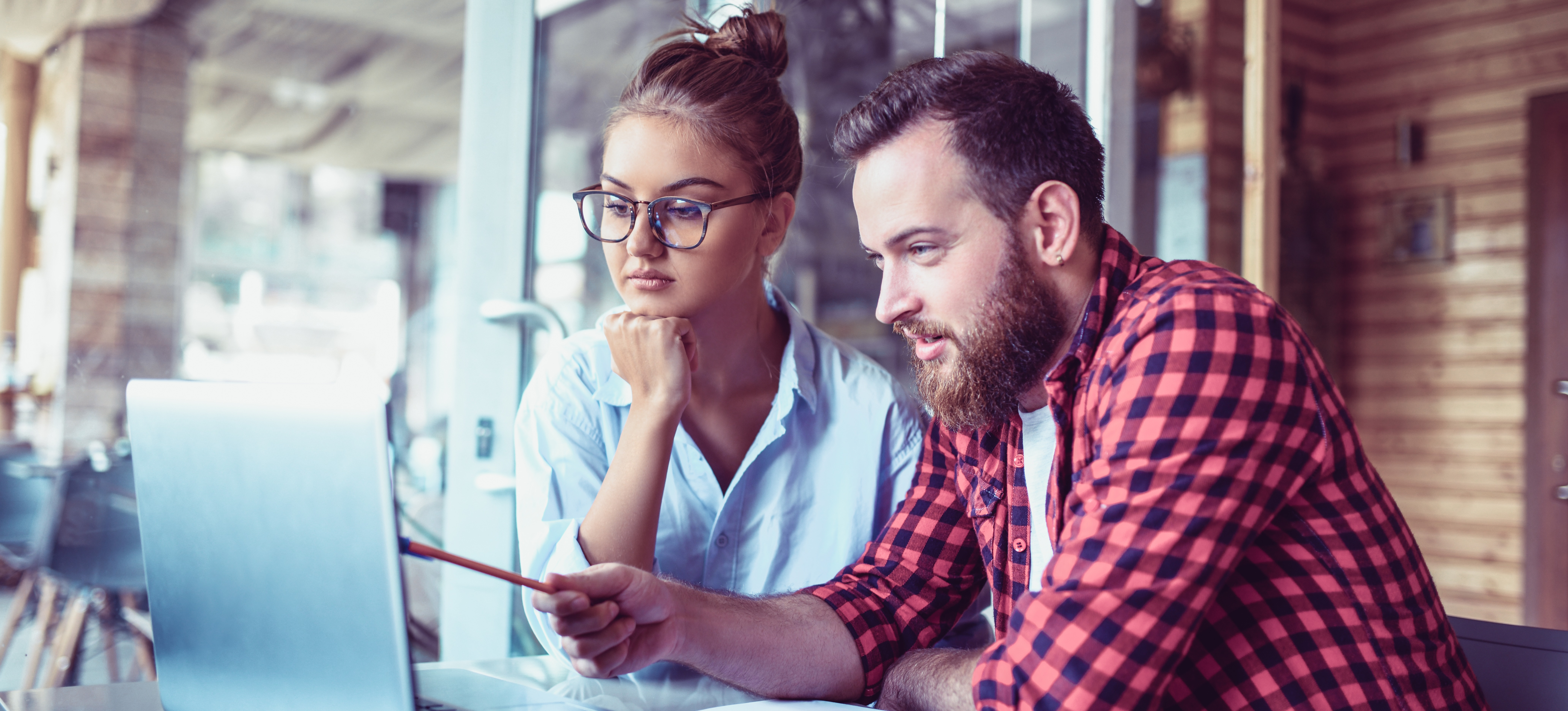 [Featured Image] A man and woman discuss what they see on a computer monitor while studying for Python certification.
