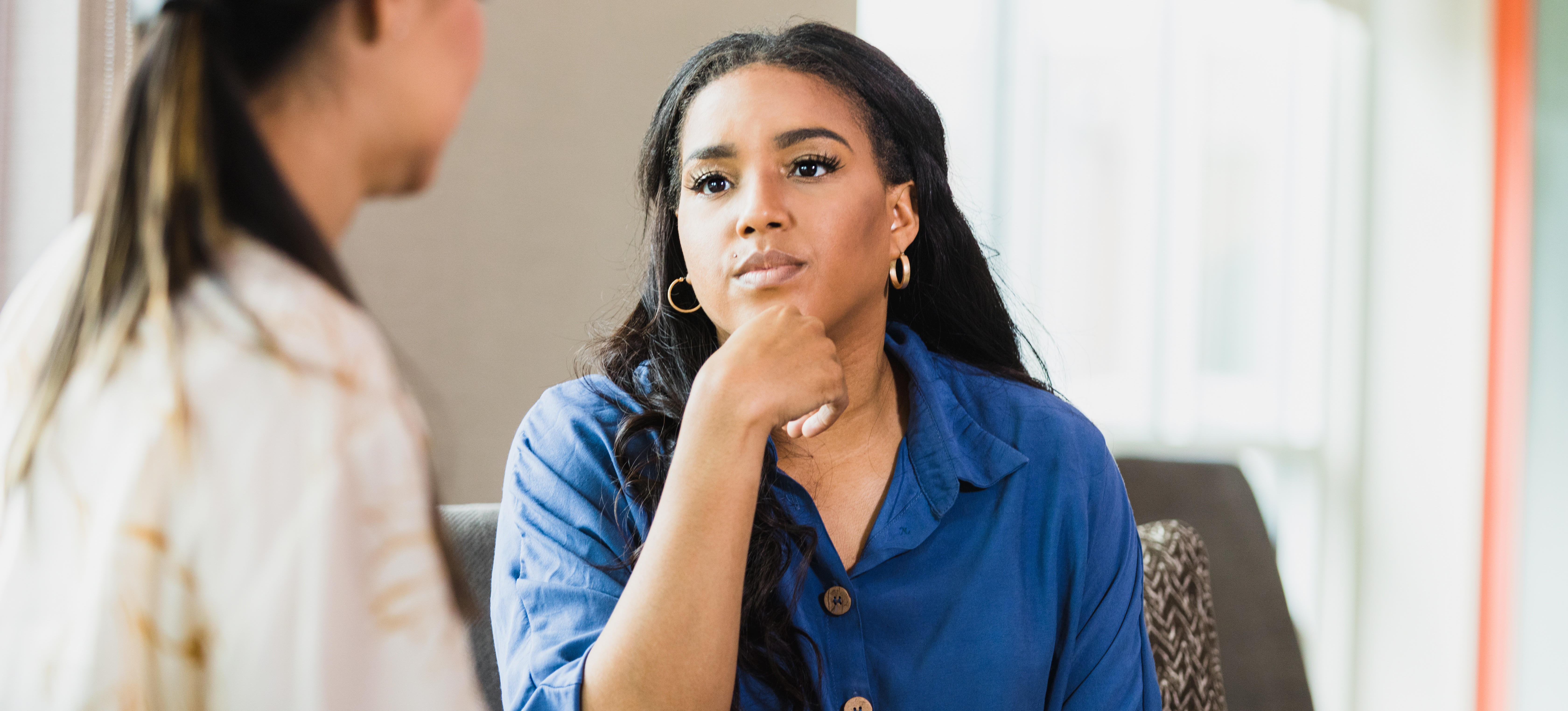 [Featured Image] A psychiatrist takes notes and listens to a patient talk about their problems. 