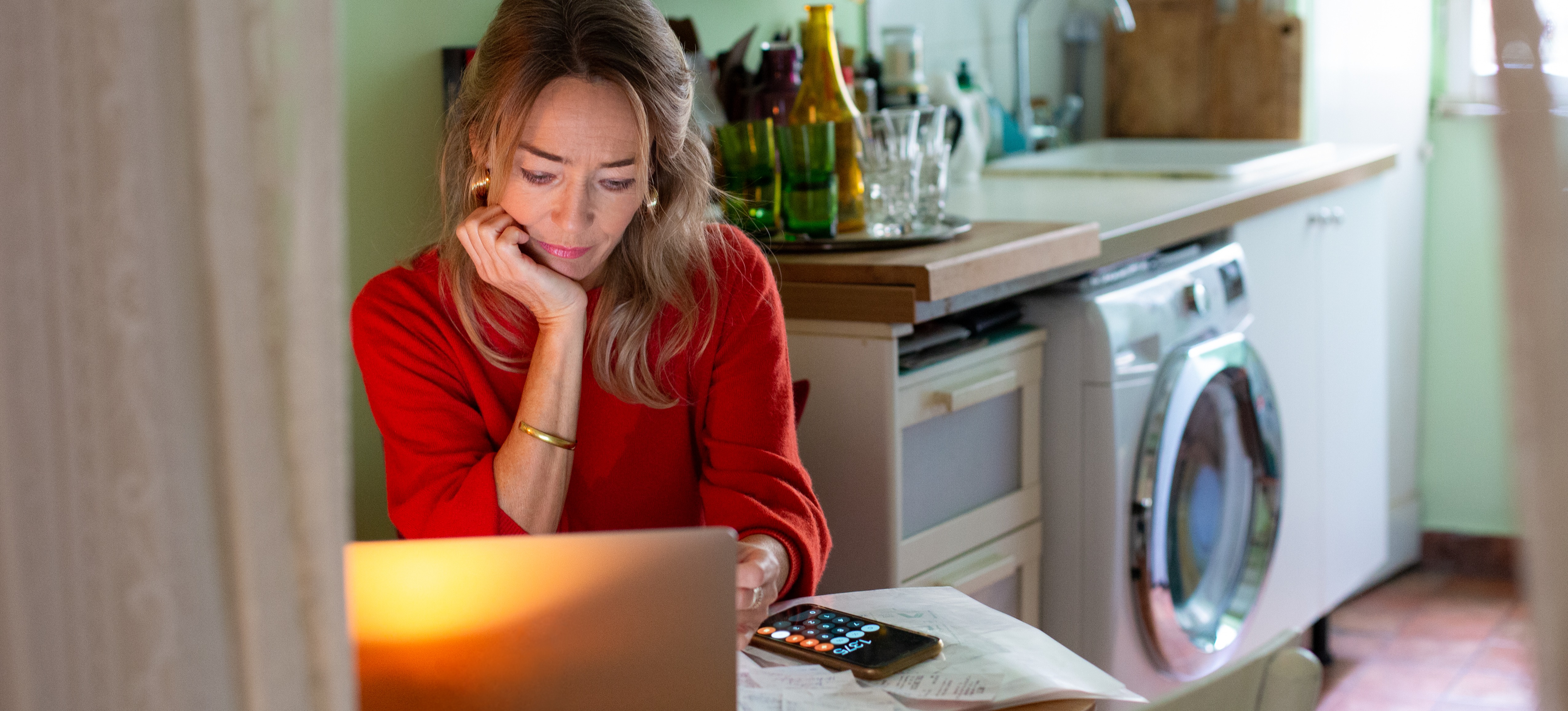 [Featured Image] A woman sits at her table at home with her laptop and searches for small business ideas.