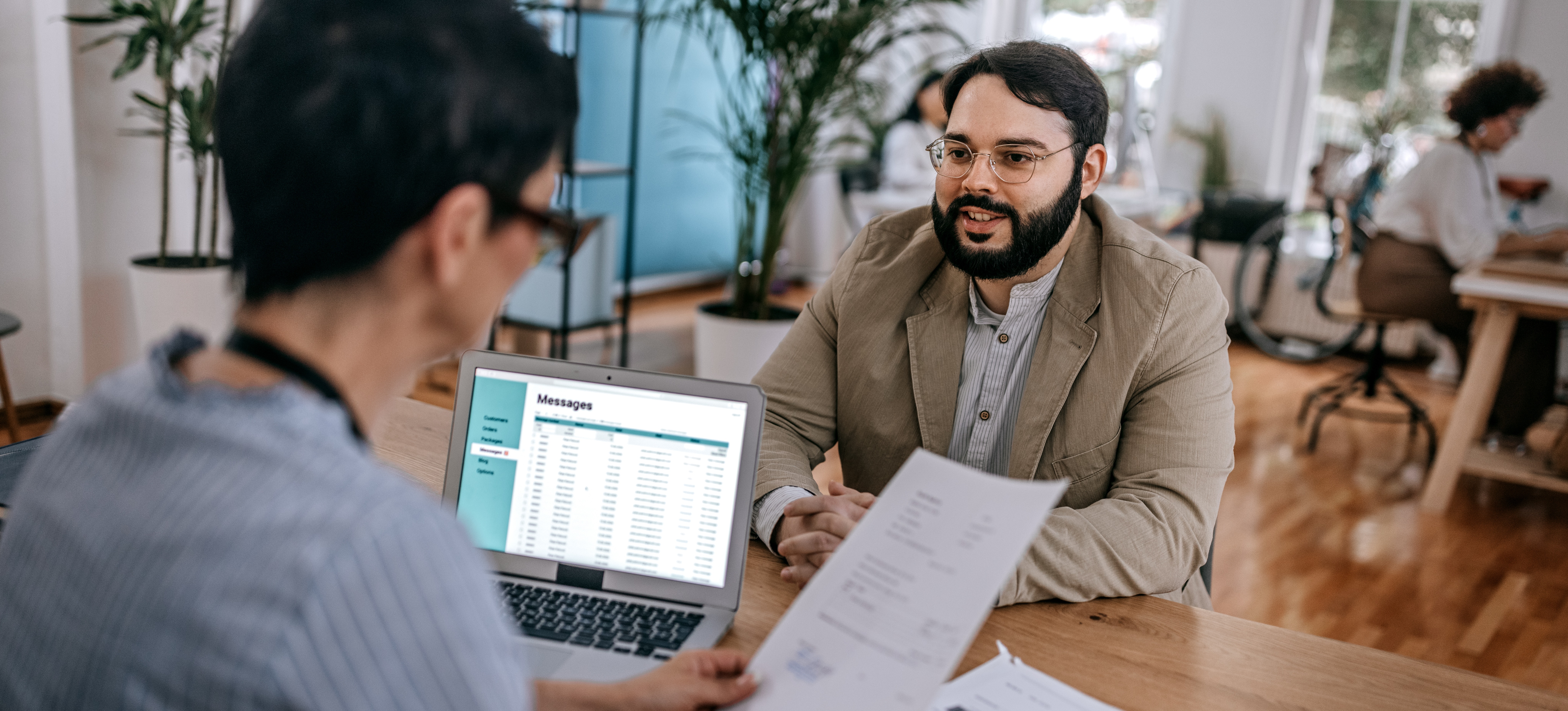 [Feature Image] After preparing with practice sales analyst interview questions, one job candidate smiles and confidently begins their job interview.
