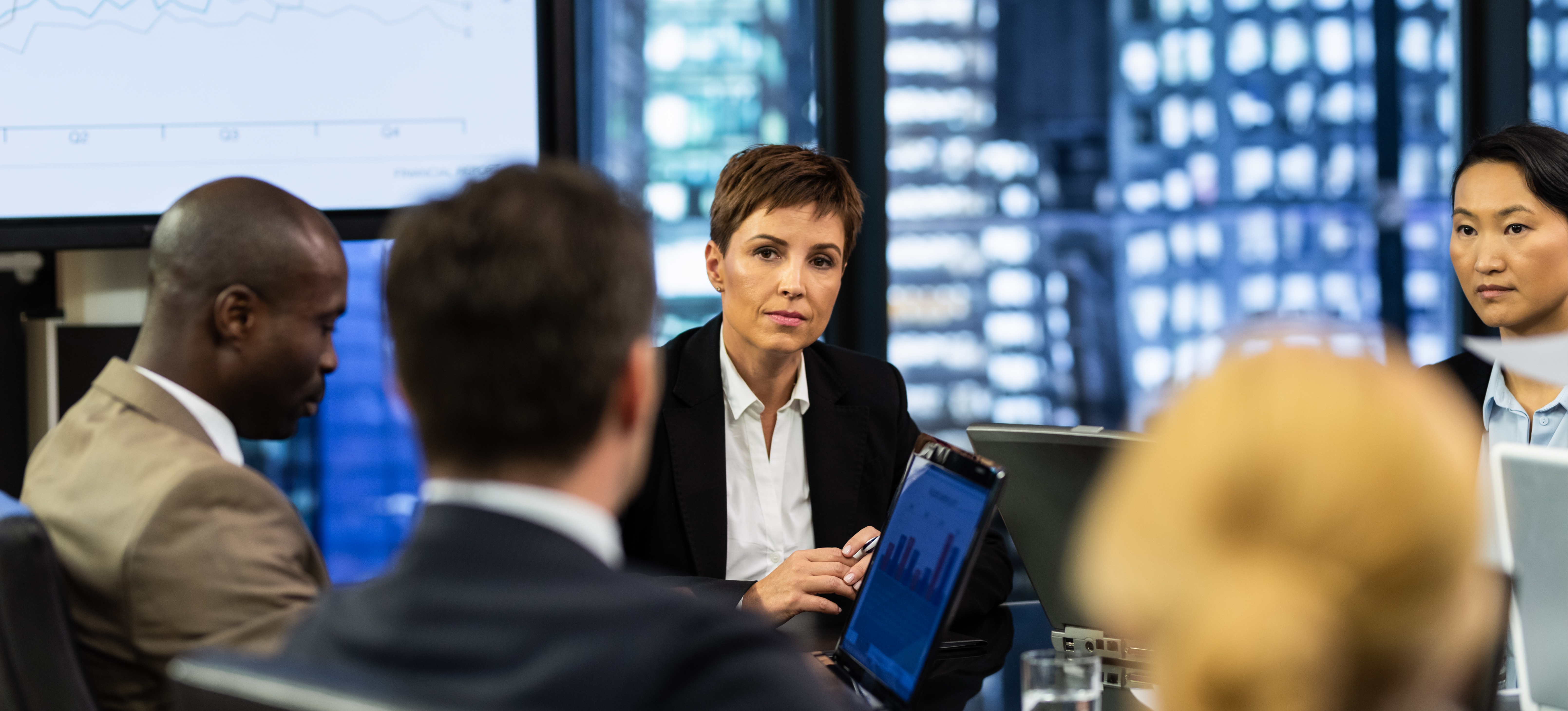 [Featured Image] A team of financial analysts at a table discussing the latest business performance insights.
