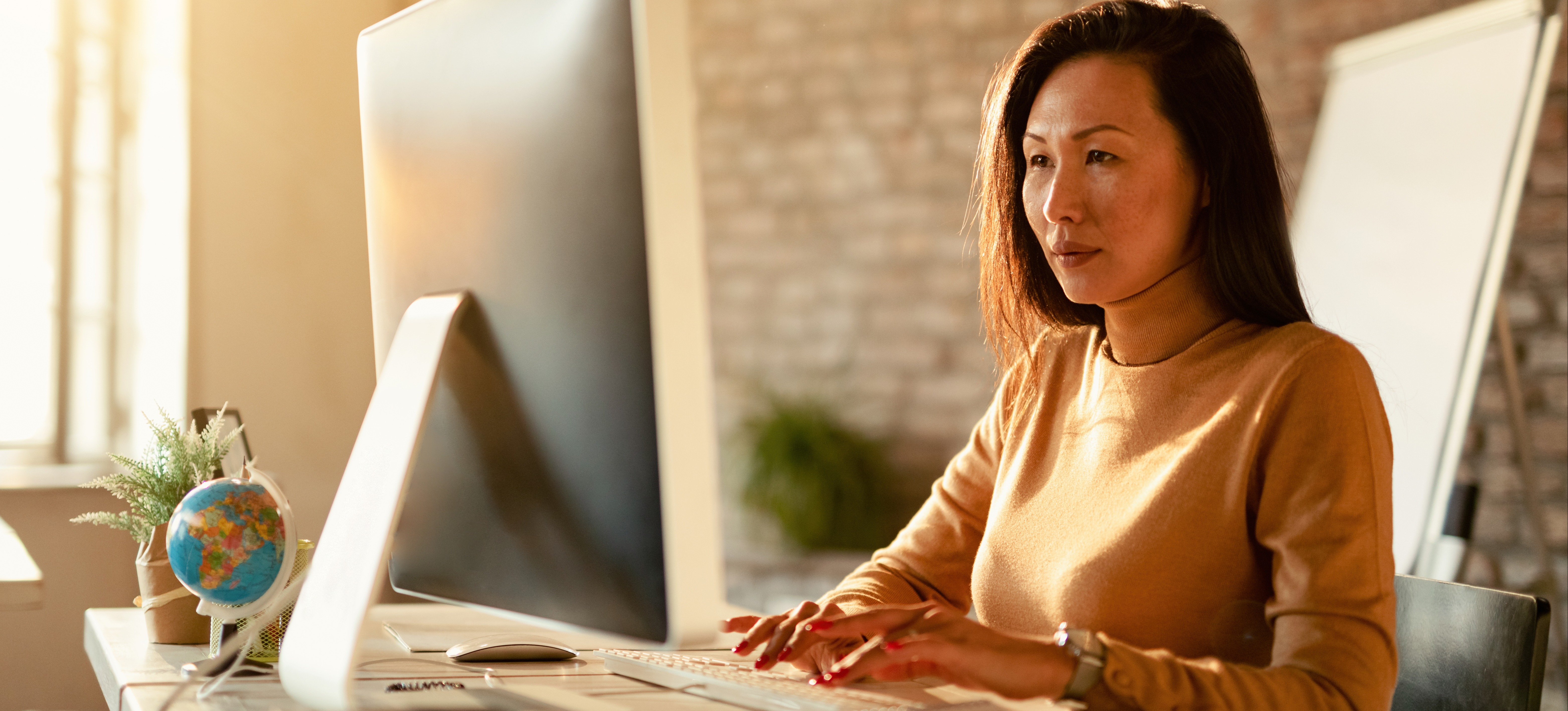 [Featured Image] A data scientist sits at a computer, using neural network visualization tools to simplify data.
