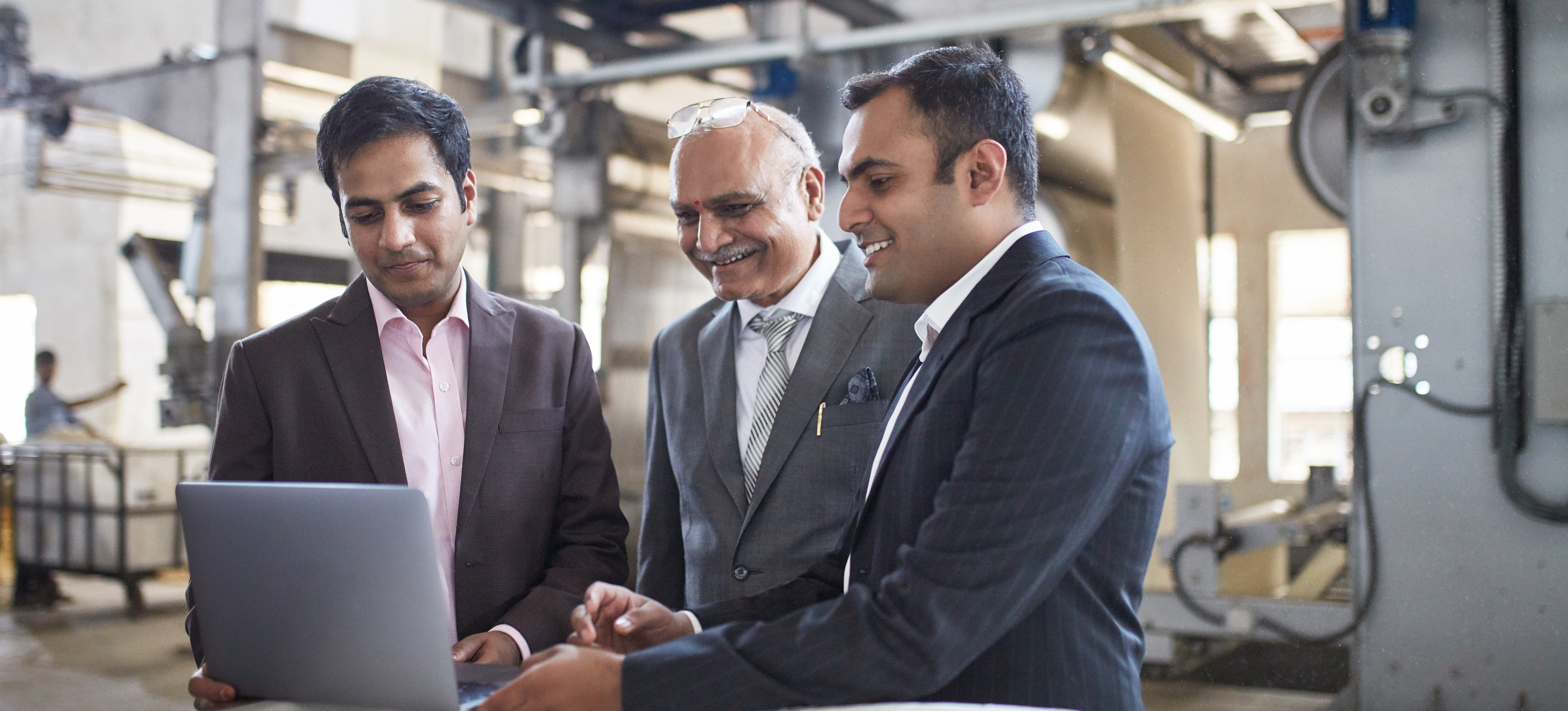 [Featured Image]: Three men review data about business operations shared by a quality assurance analyst.
