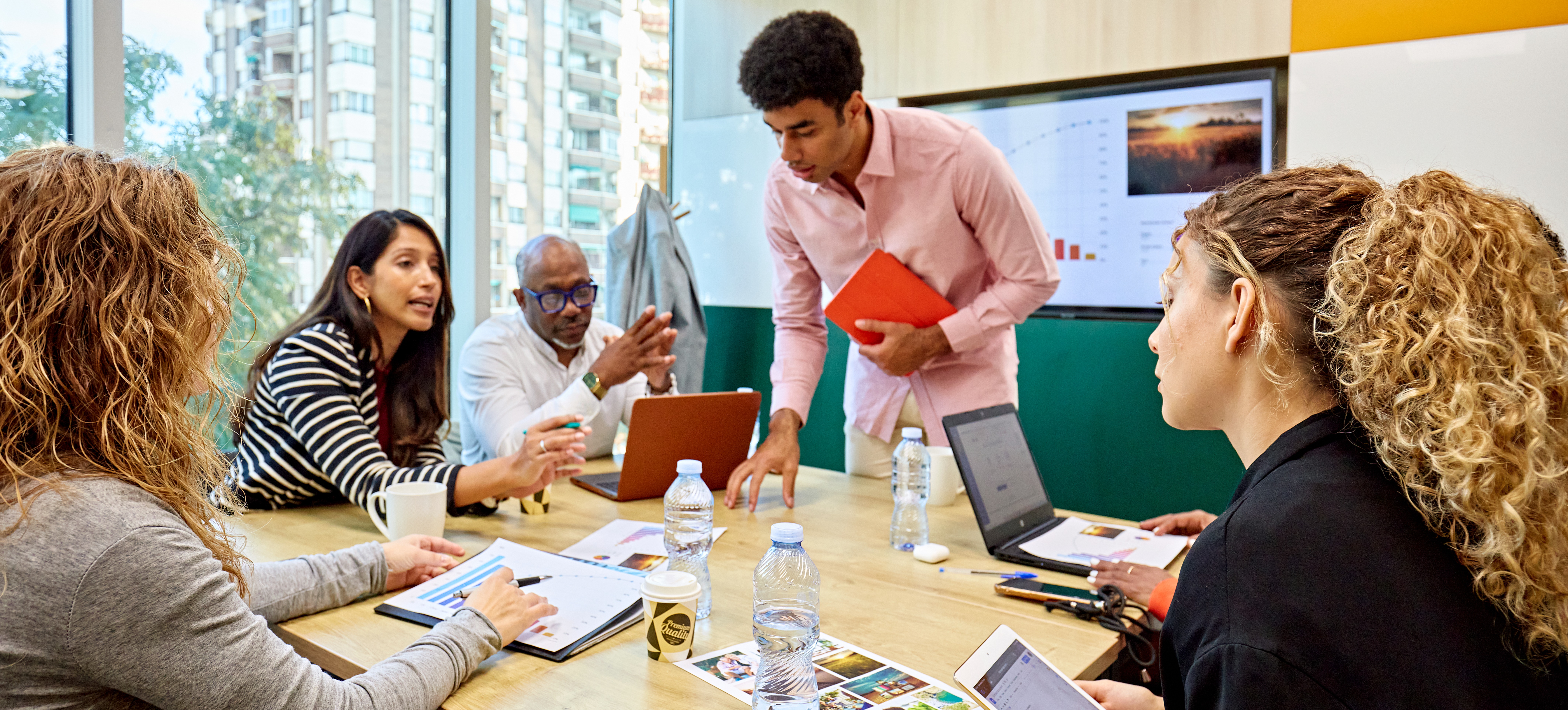[Featured Image] A project manager meets with a group to discuss their statement of work.
