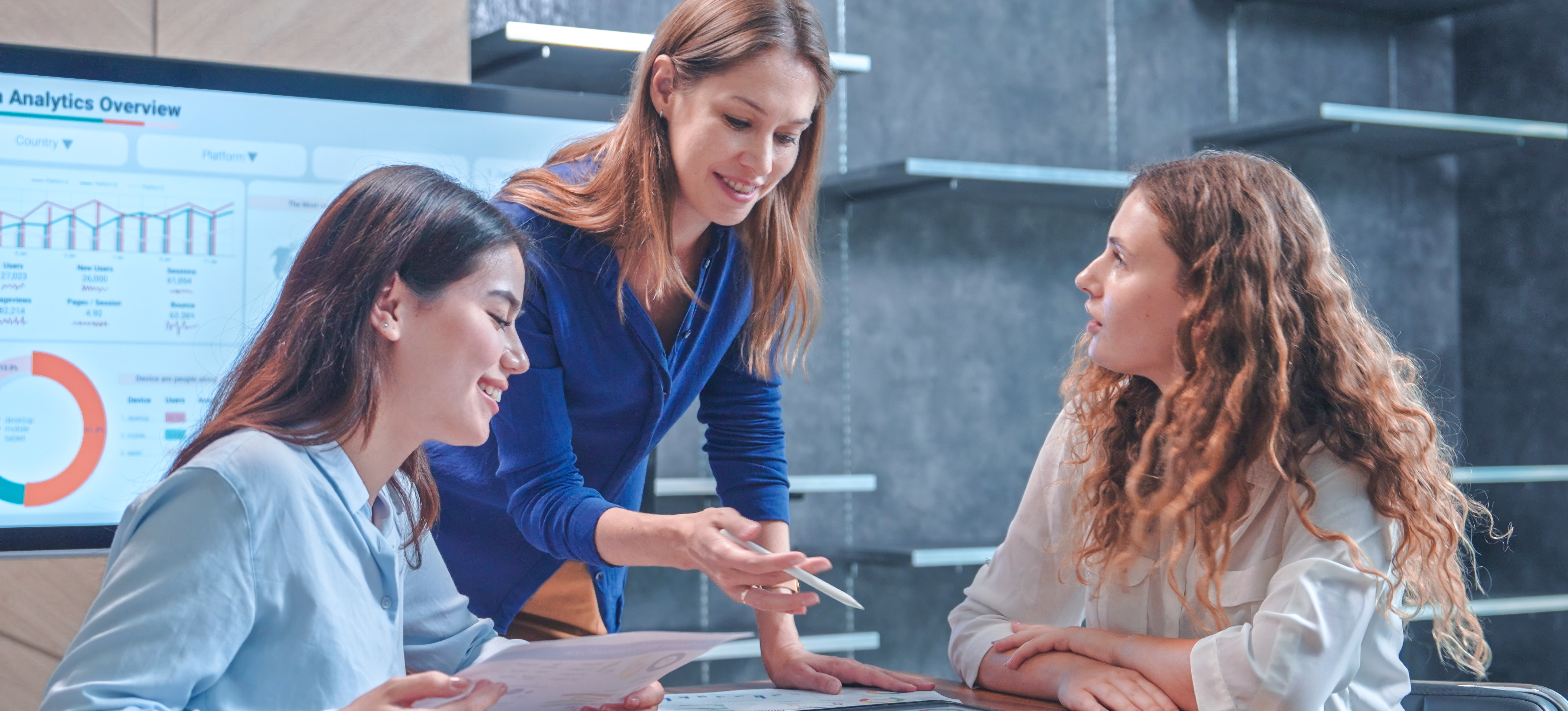 [Featured Image] New hires meet with the head of HR to discuss the product analyst salary at the company and the potential for additional compensation and benefits. 
