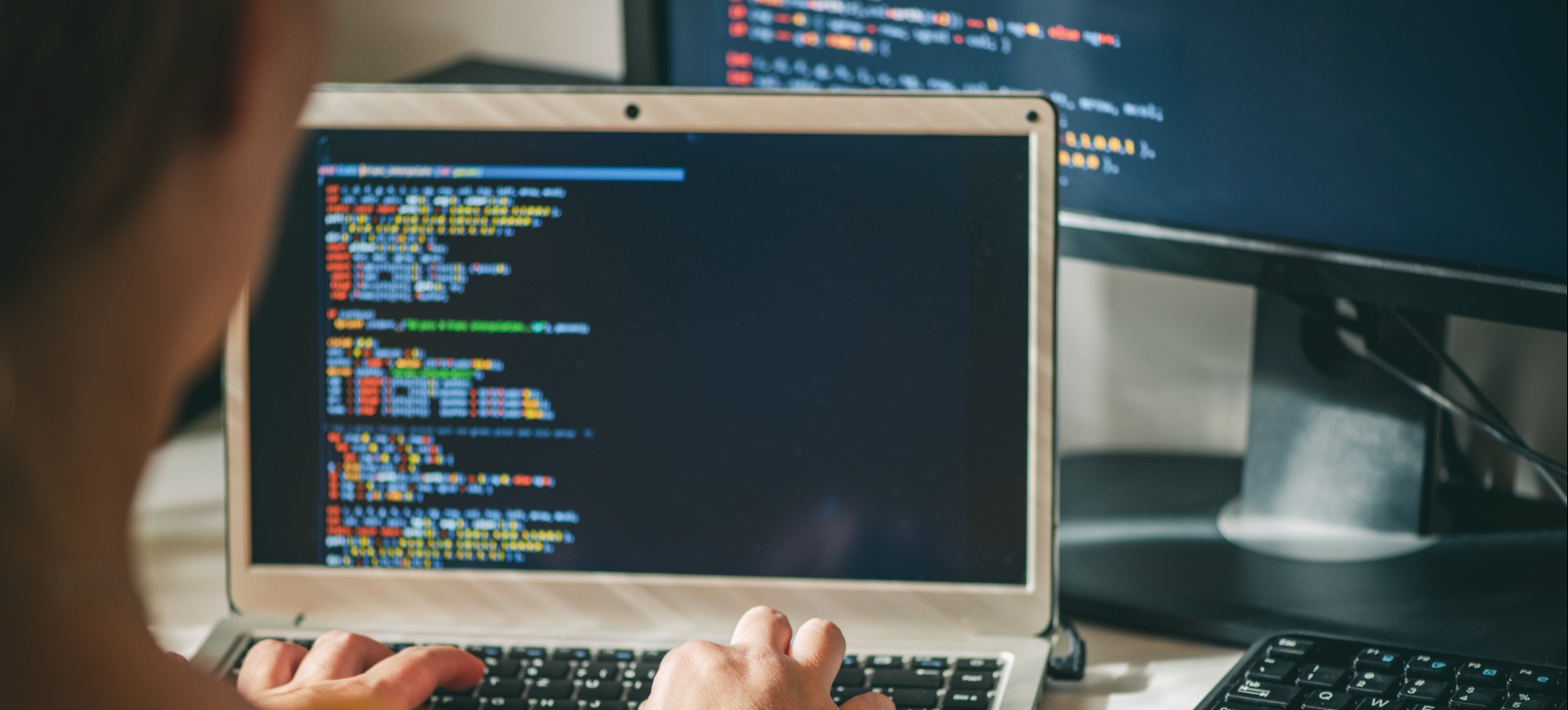 [Hauptbild] Ein Softwareentwickler programmiert auf seinem Laptop.