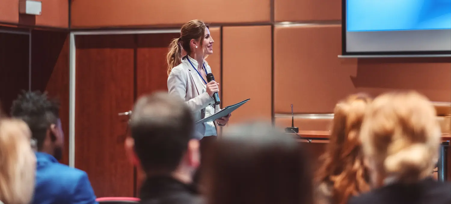 [Featured Image]: A management science expert is speaking at a convention.
