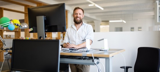 [Featured image] A data engineer works on maintaining a data warehouse. He's standing at his workstation in front of a large computer monitor.