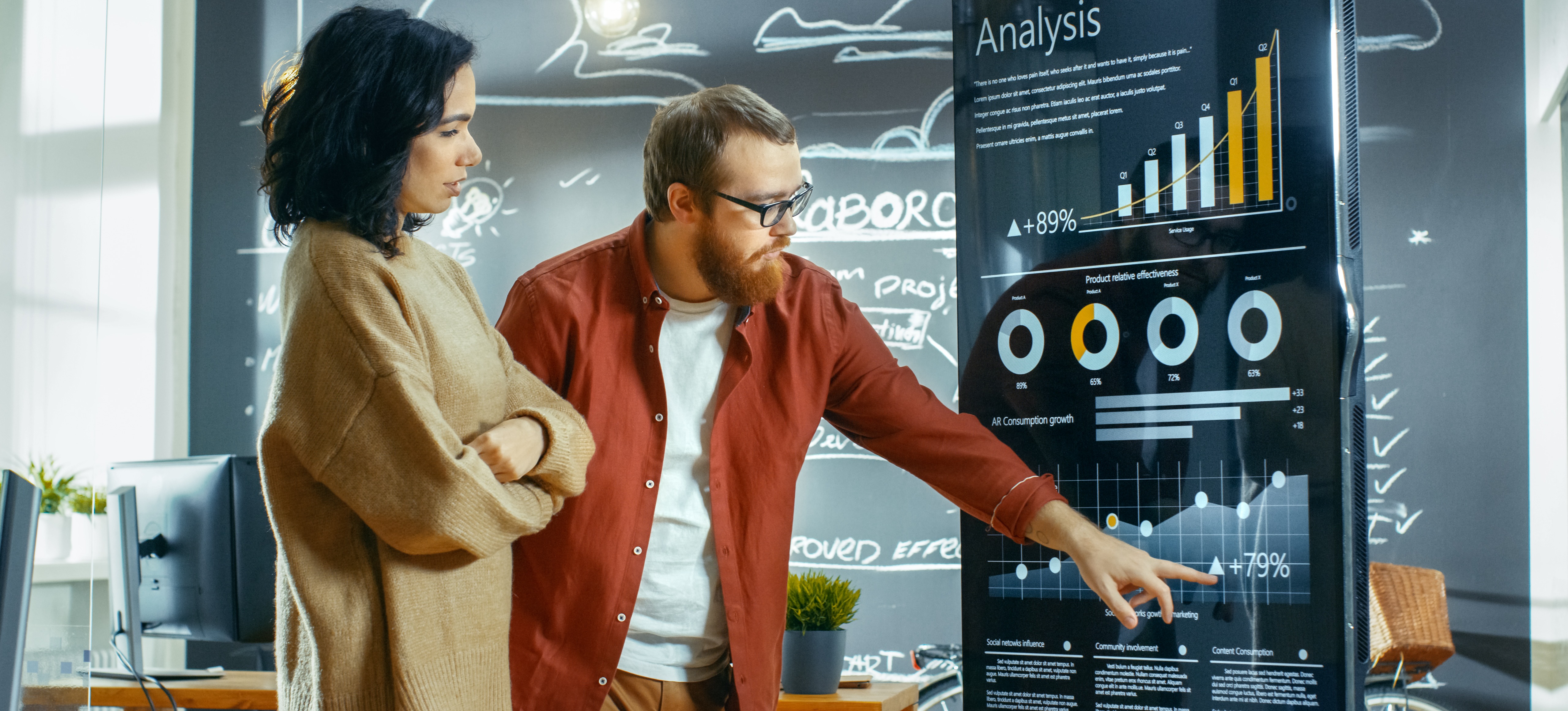 [Feature Image] Statisticians study charts in front of a blackboard