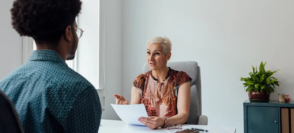 [Featured image] Recruiter discussing software engineer job description with a candidate during an interview.