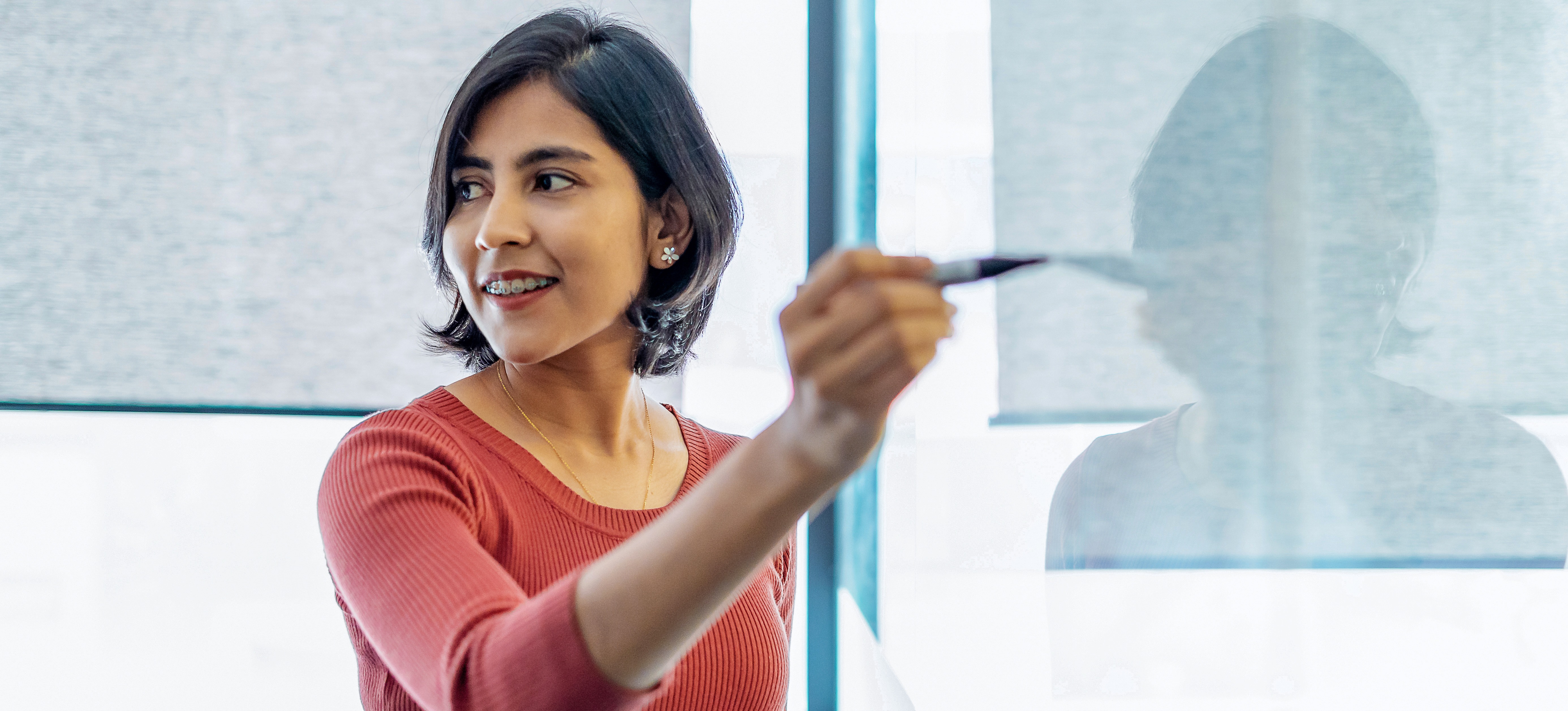 [Featured Image] A software engineer gives her colleagues a presentation on implementing a new data warehouse. 
