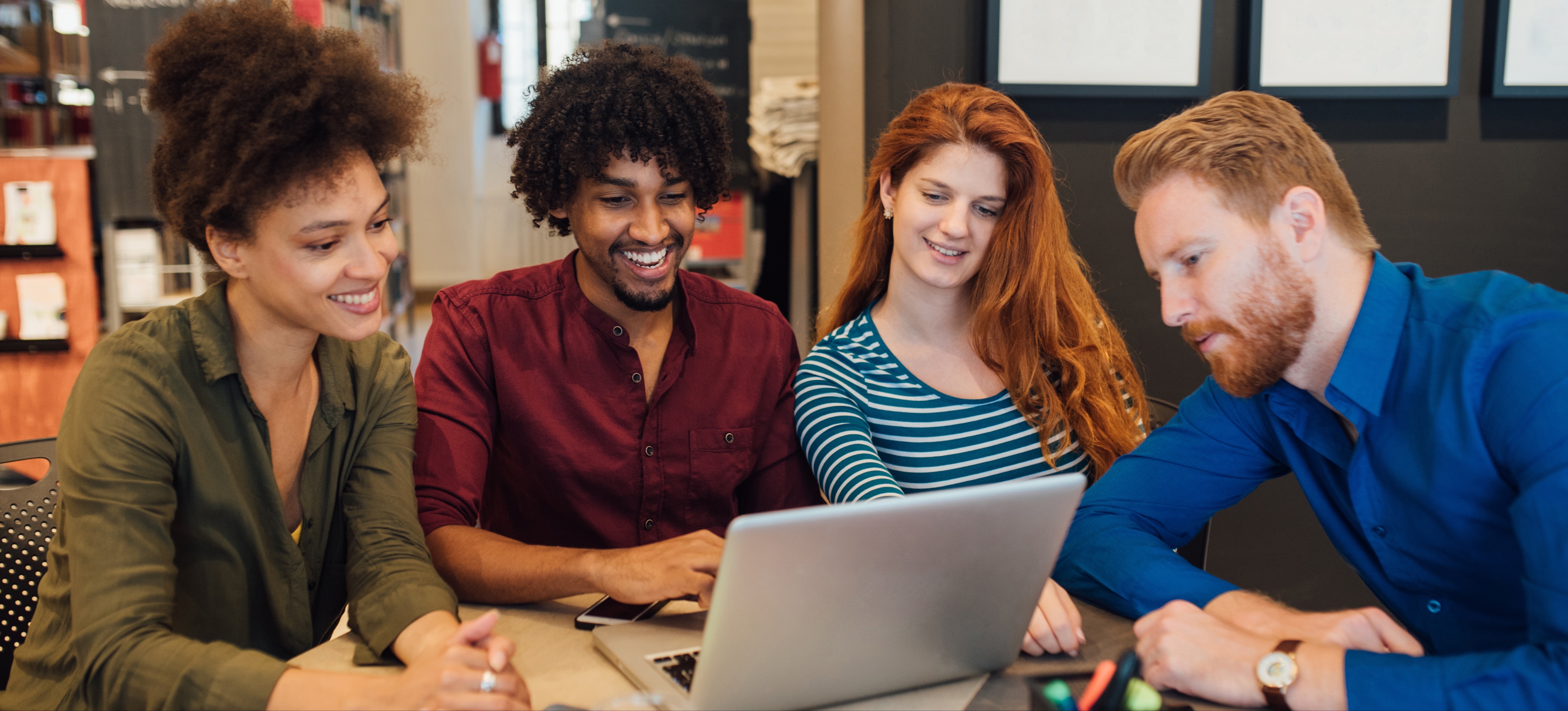 [Featured Image] A team of professionals in a workplace, all looking at a computer screen with a video about green IT Certification.
