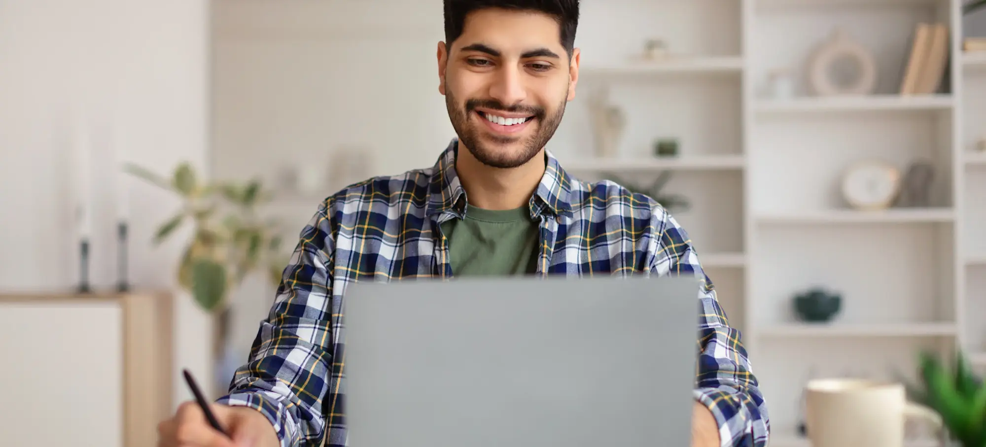 [Featured Image] A learner sits in front of a laptop while working on one of many online degree programmes in the USA.