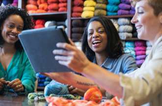 [Featured image] Three people work on a niche market plan for their yarn business.