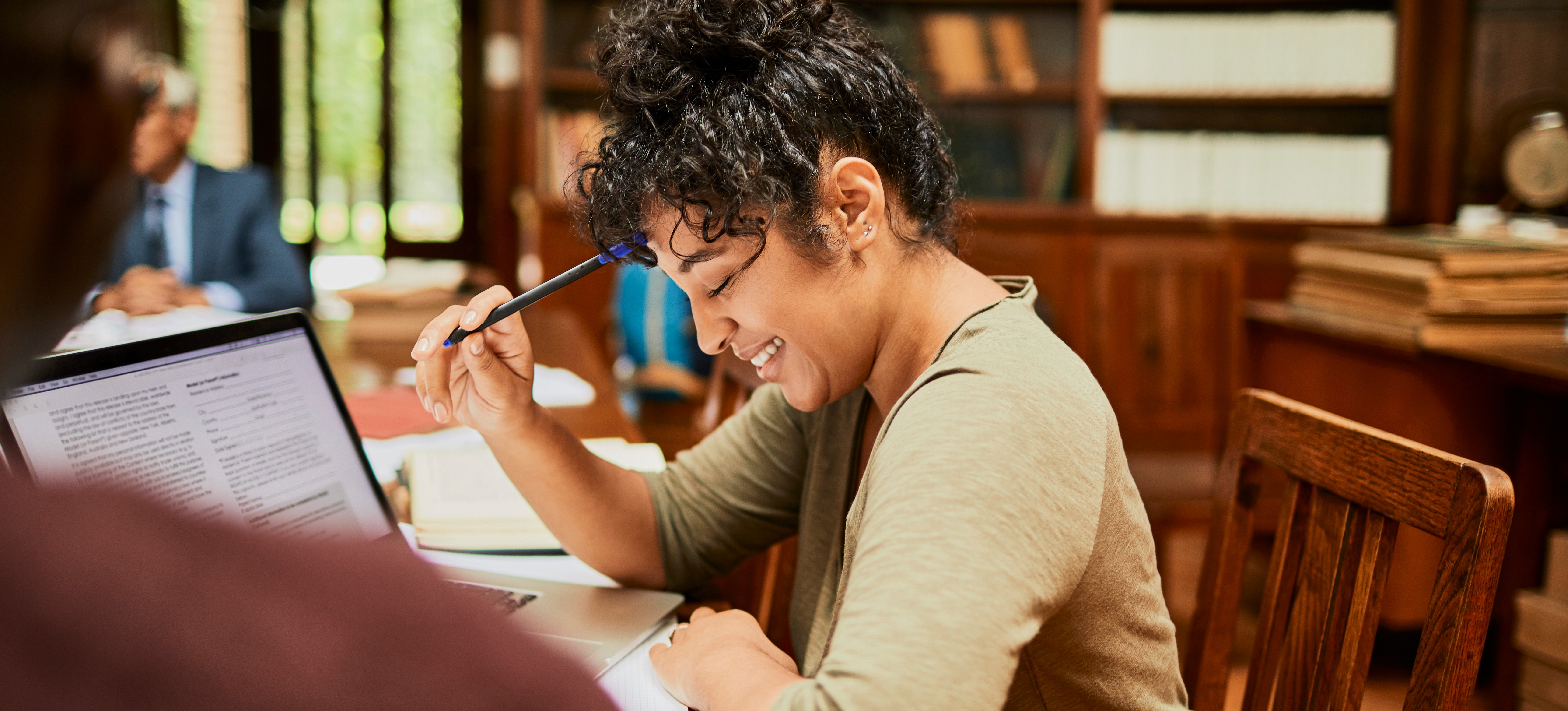 [Featured image] A person working on their science degree studies in a university library.