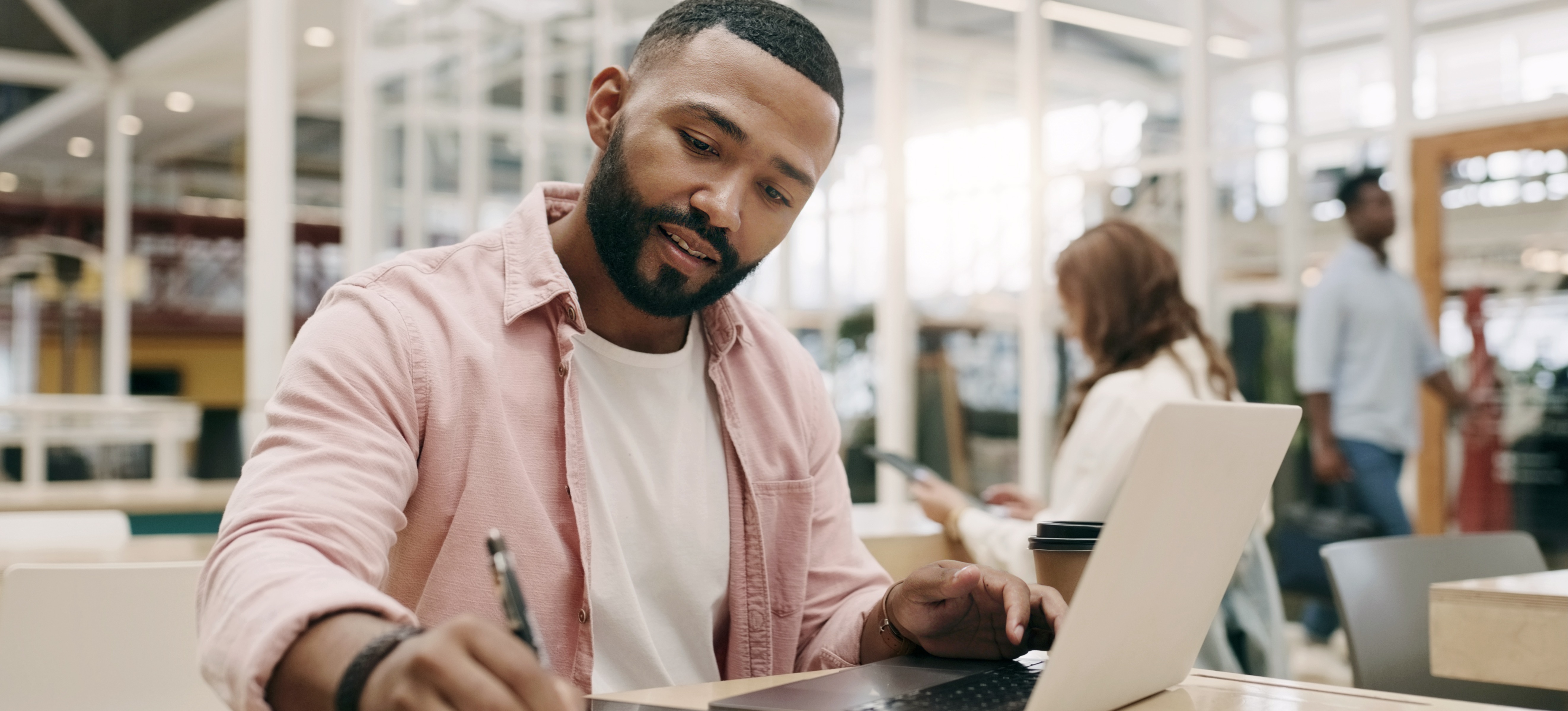 [Featured image] A data analyst sits at a laptop and takes notes on some data they discovered with high data granularity.  