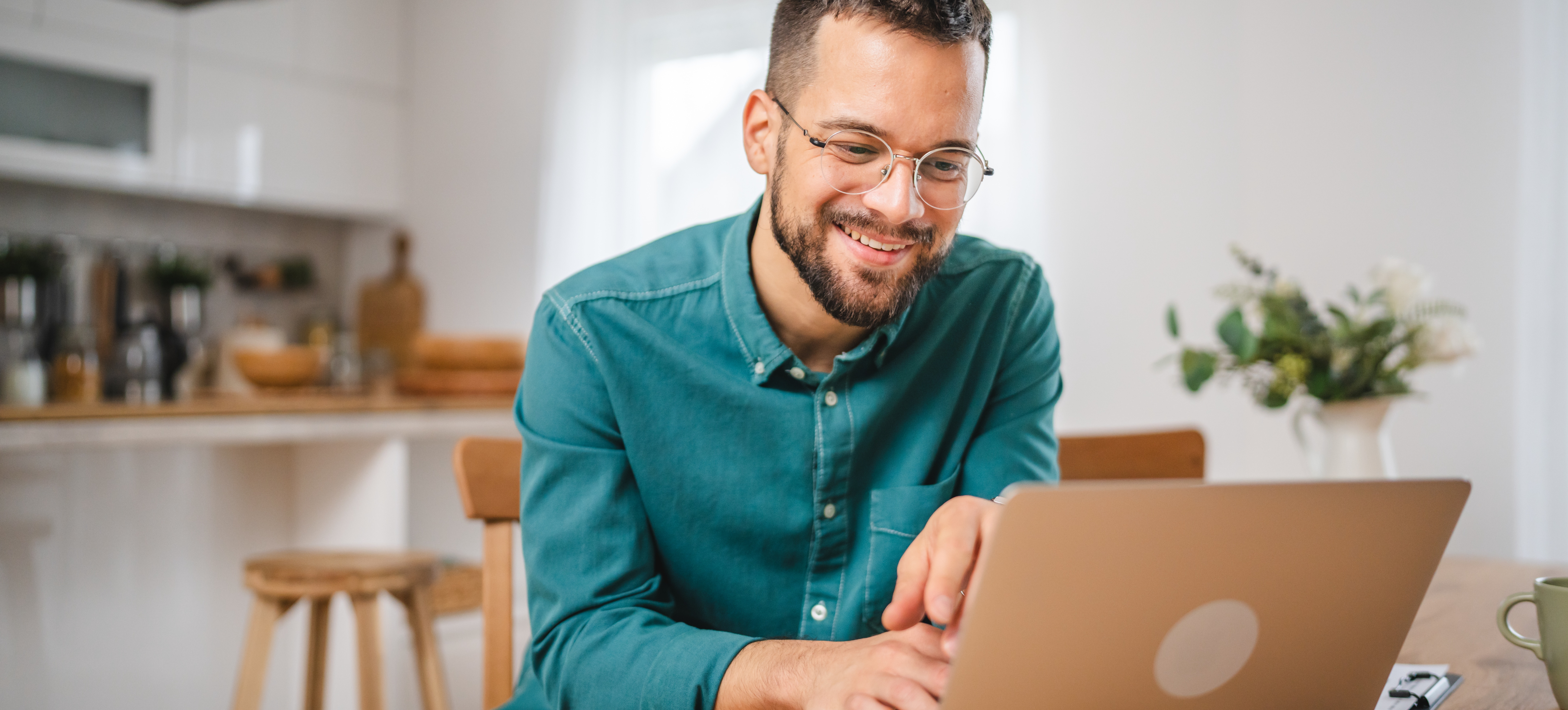 [Featured Image] A learner smiles at their laptop as they prepare for the Splunk certification while studying at home. 