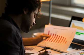 A student working on marketing graph statistics concept.