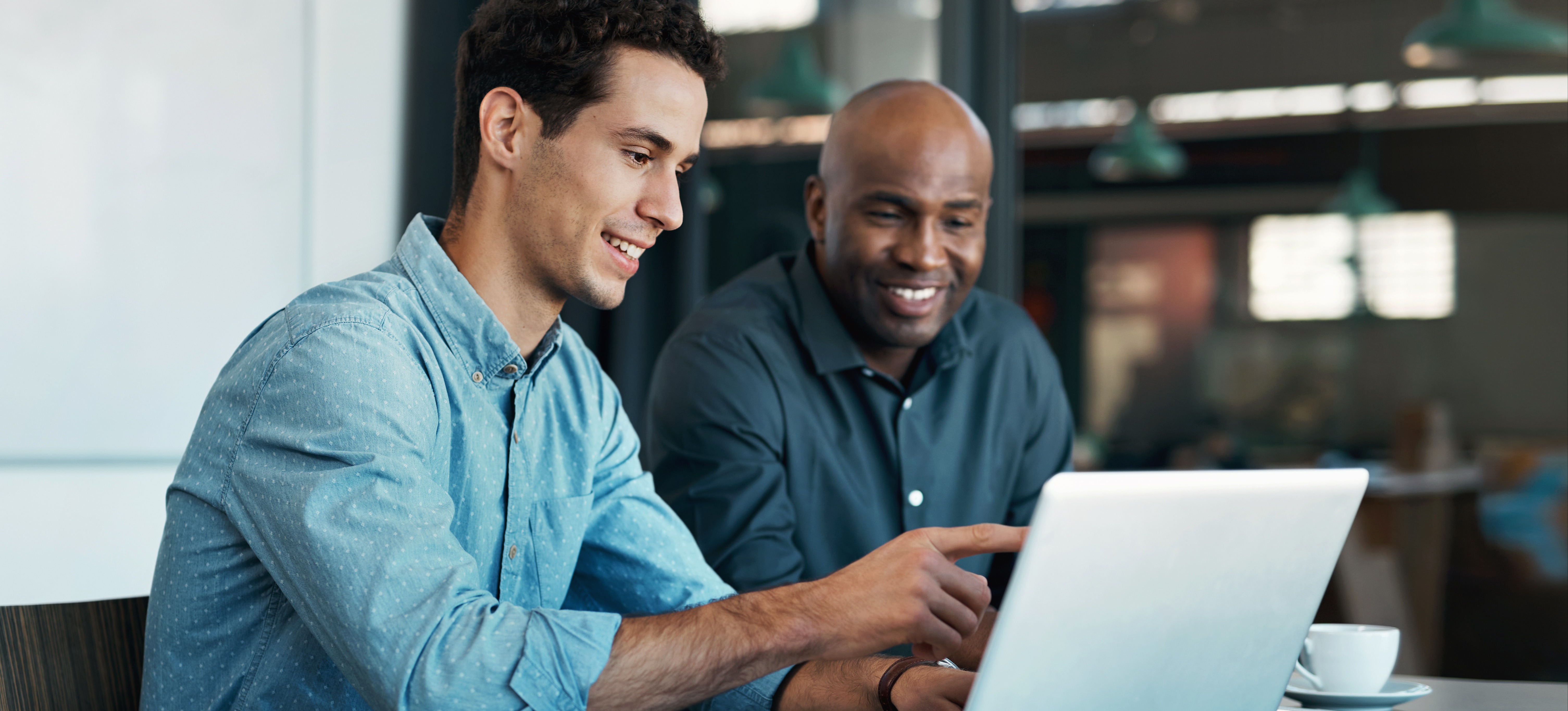 [Featured Image] Information security professionals interacting in a professional environment, discussing entry-level information security certifications.

