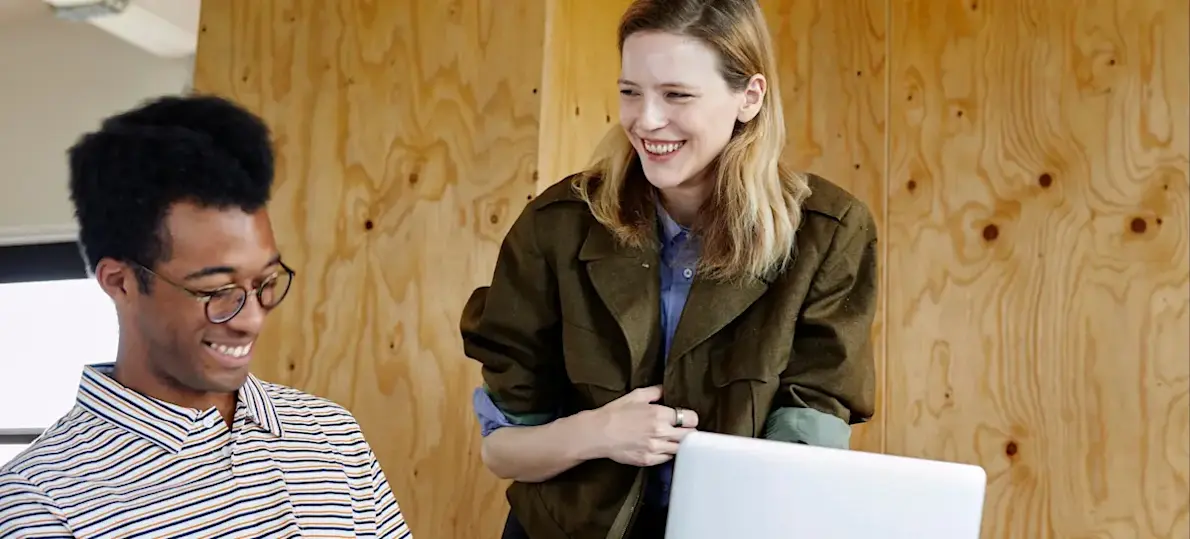 [Featured Image] Two workers are discussing usability.