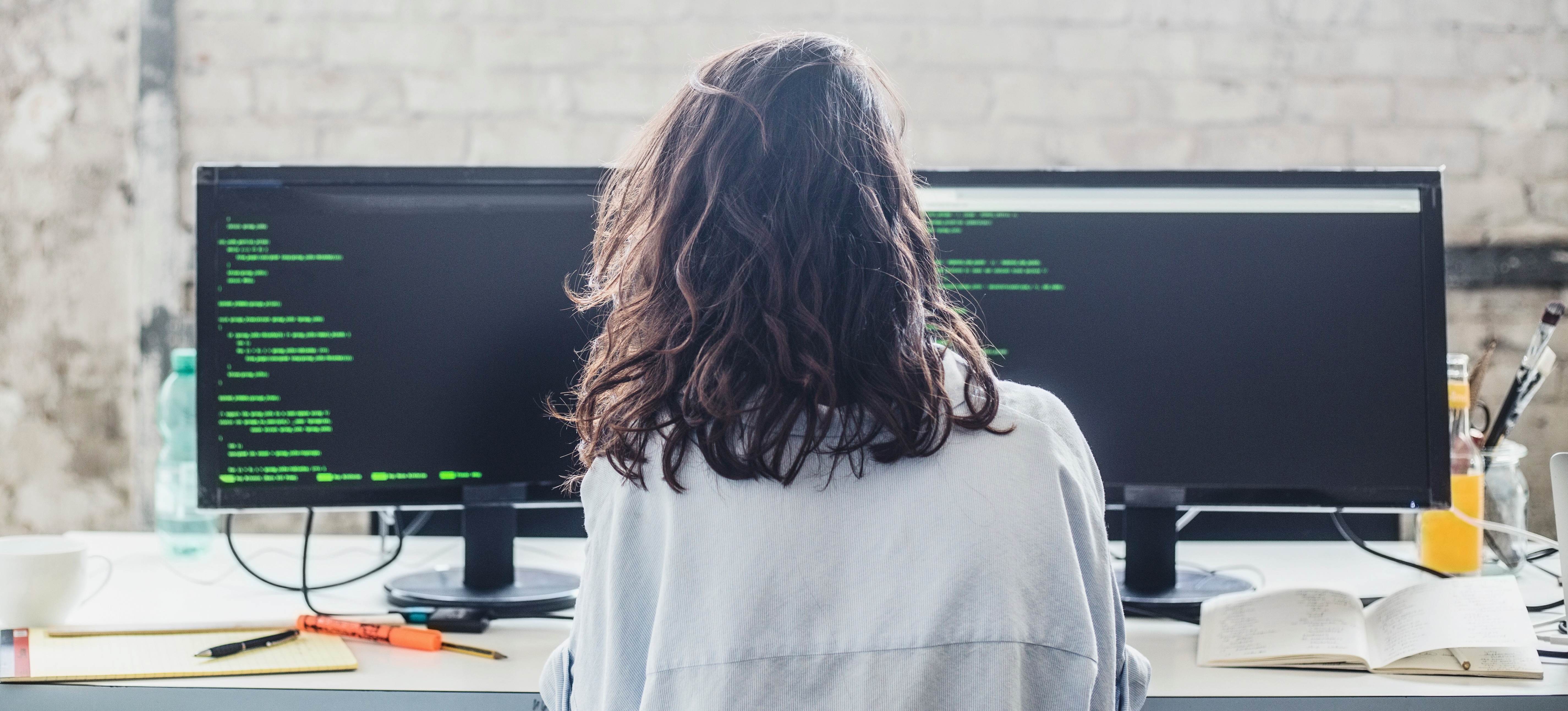 [Featured Image] A machine learning engineer looks at code for AI software on their computer.