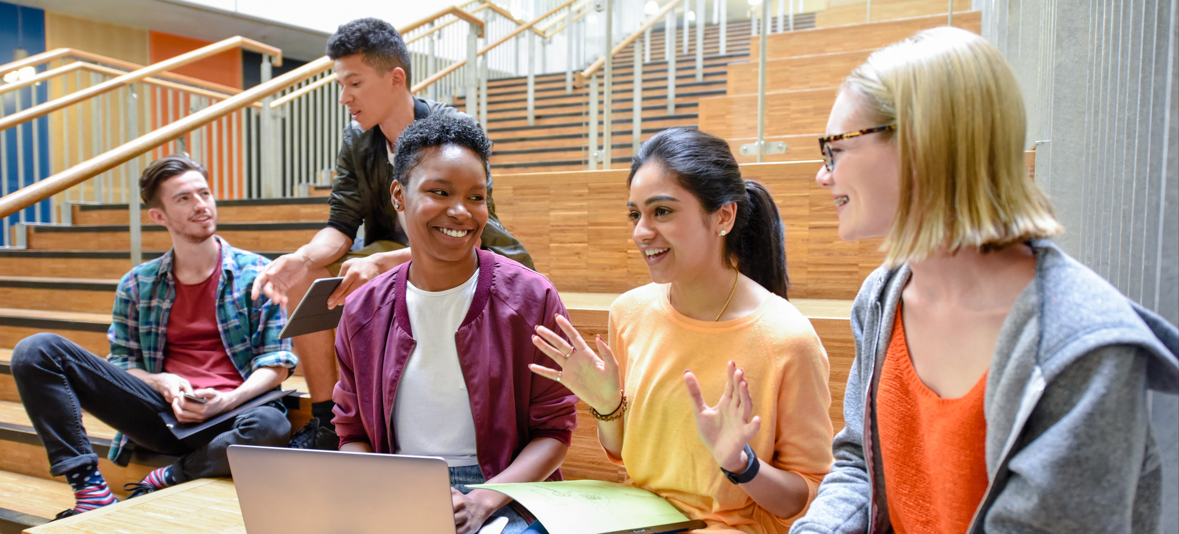 [Featured image] Group of employees meeting and discussing plans