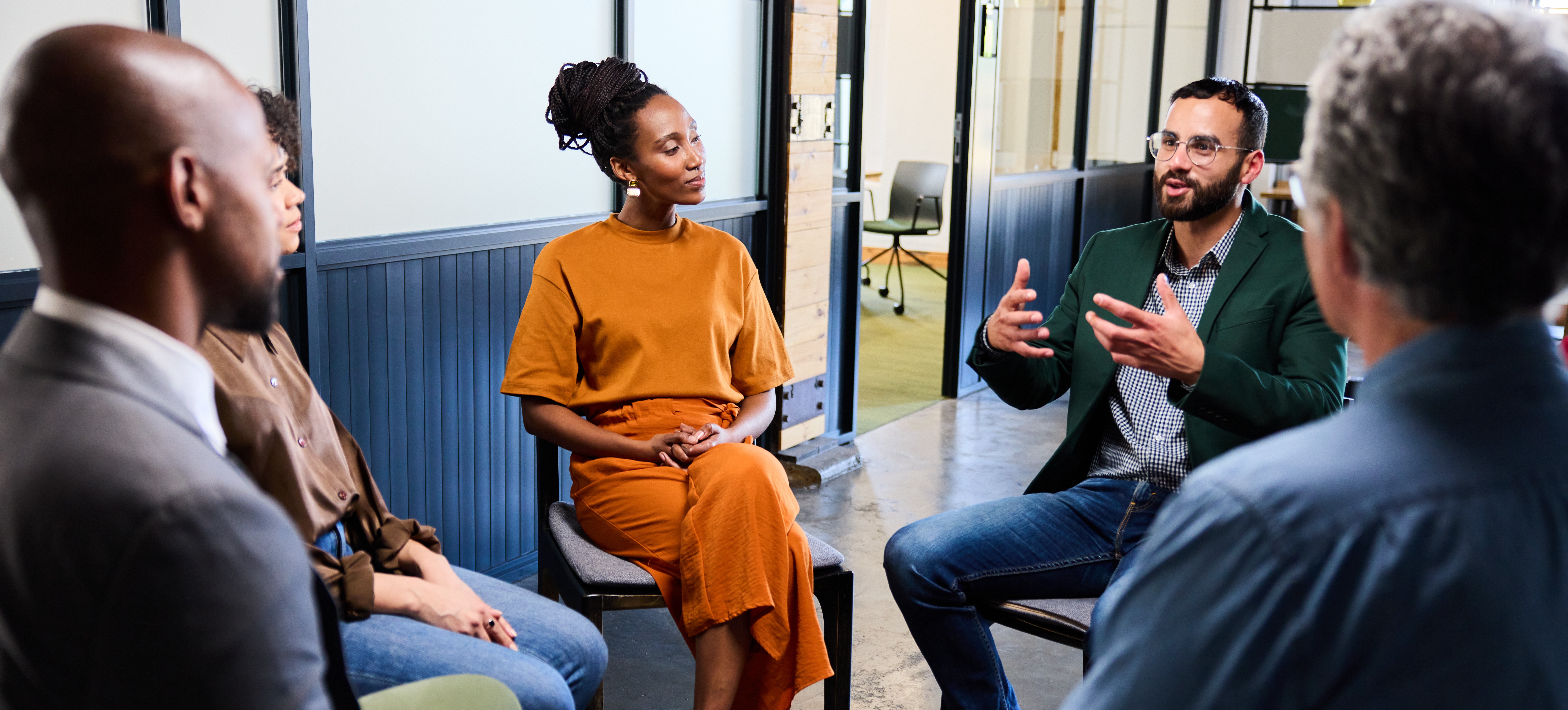 [Featured Image] A project manager facilitates a productive meeting using engaging group discussion questions.
