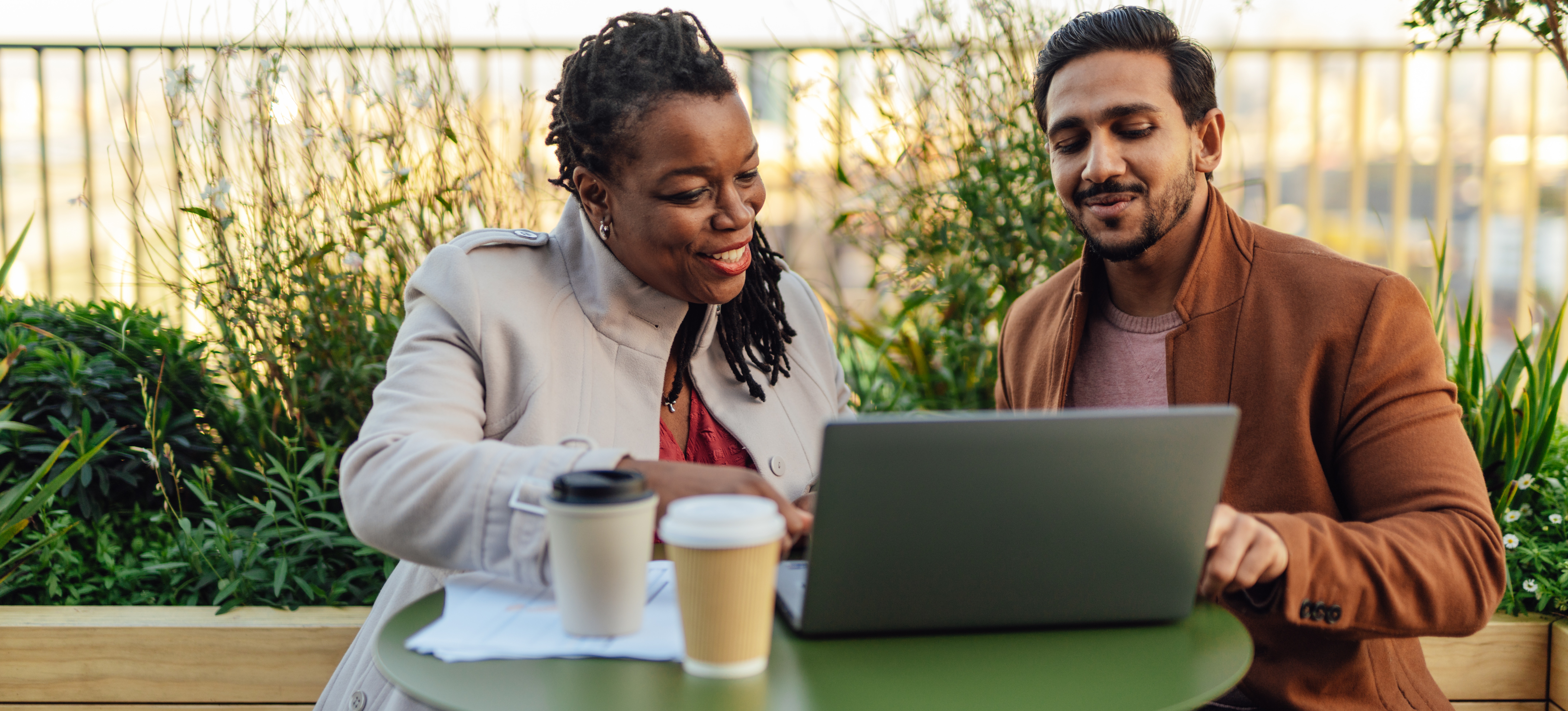 [Feature Image] Two prospective learners research available coding boot camps as they plan their learning journeys.
