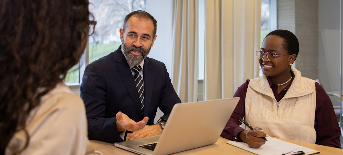 [Featured Image] A group of employees meets to discuss whether AI could be dangerous. 