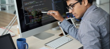 [Featured image] A machine learning engineer is looking at a program to ensure it practices machine learning fairness.