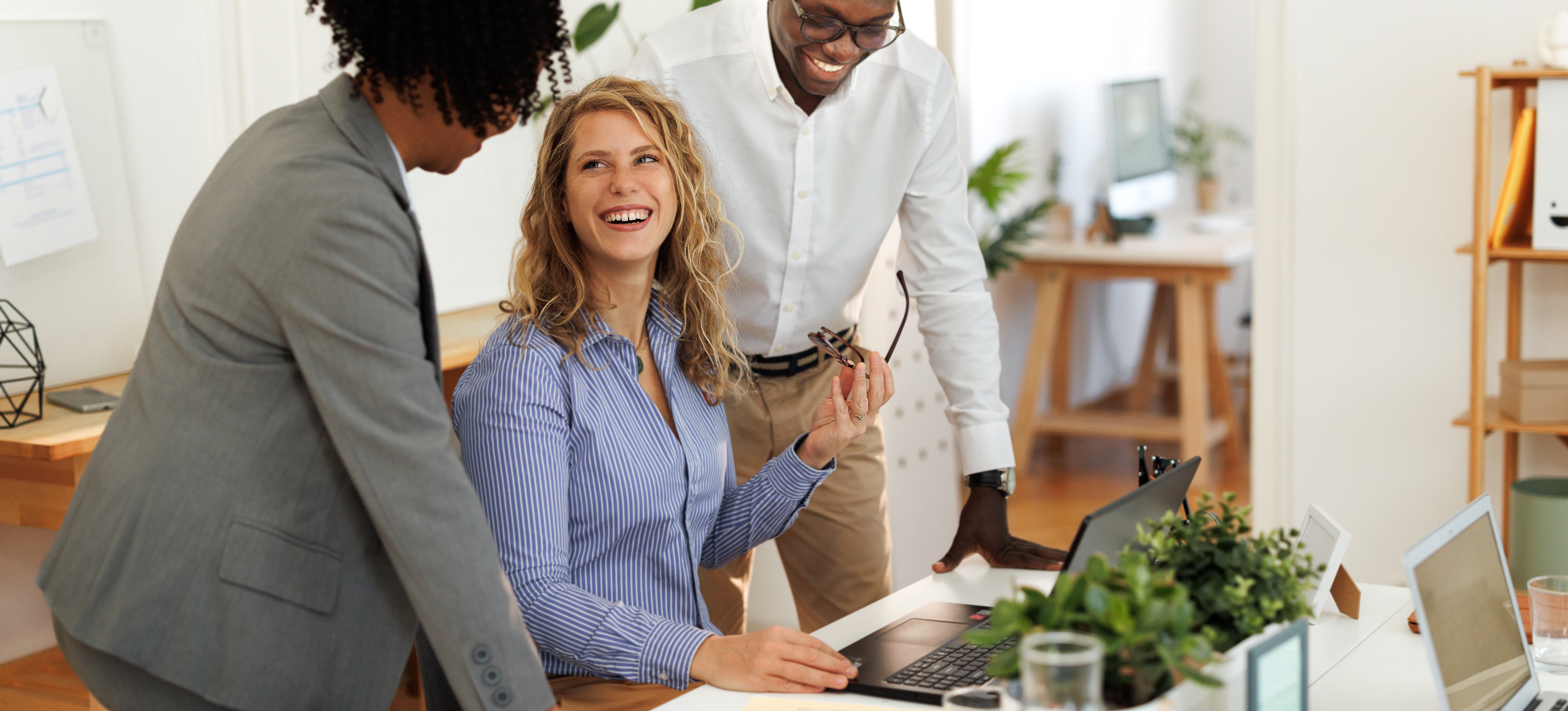 [Featured Image]: A team collaborating in a modern office environment, discussing AI cloud services.
