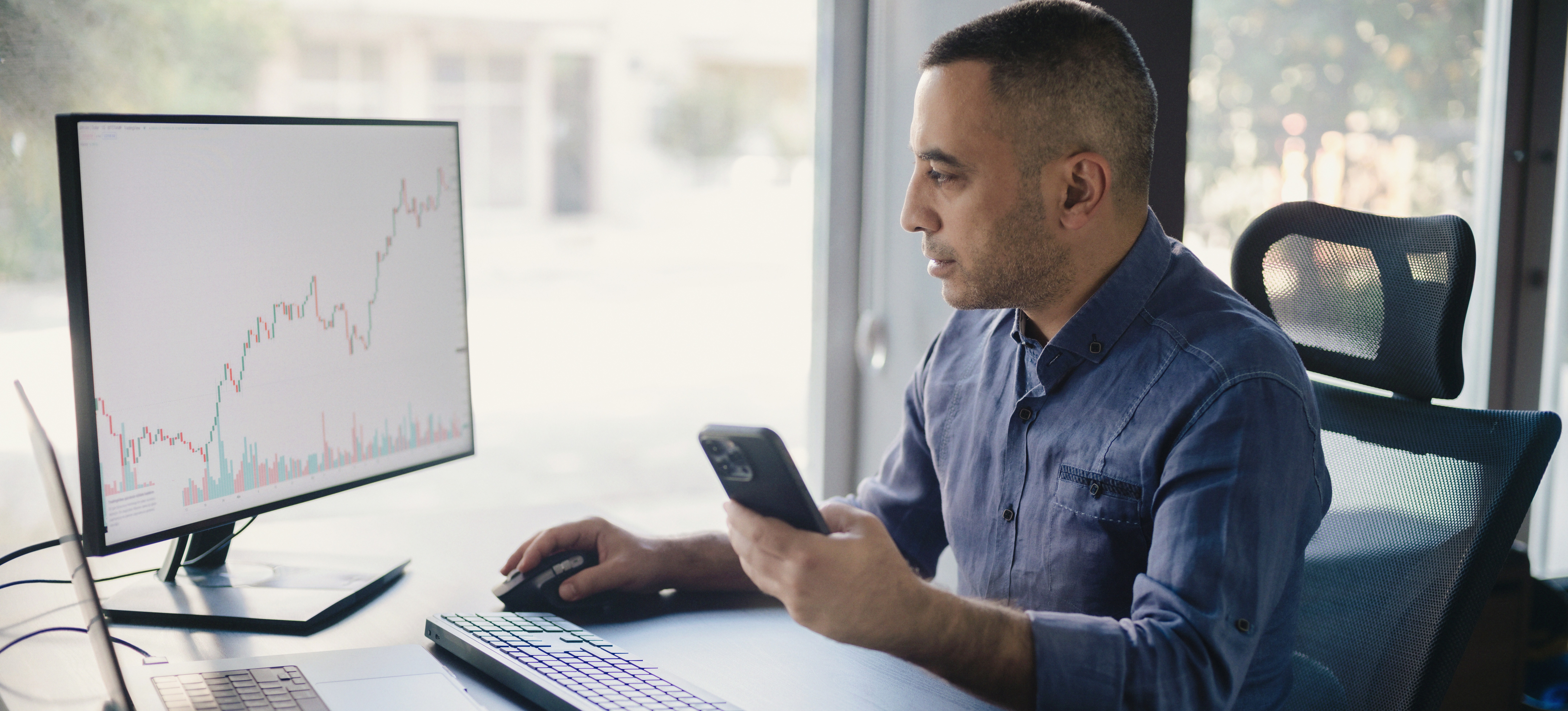 [Featured Image] A data analyst studies graphs and data on his computer screen using exploratory data analysis.
