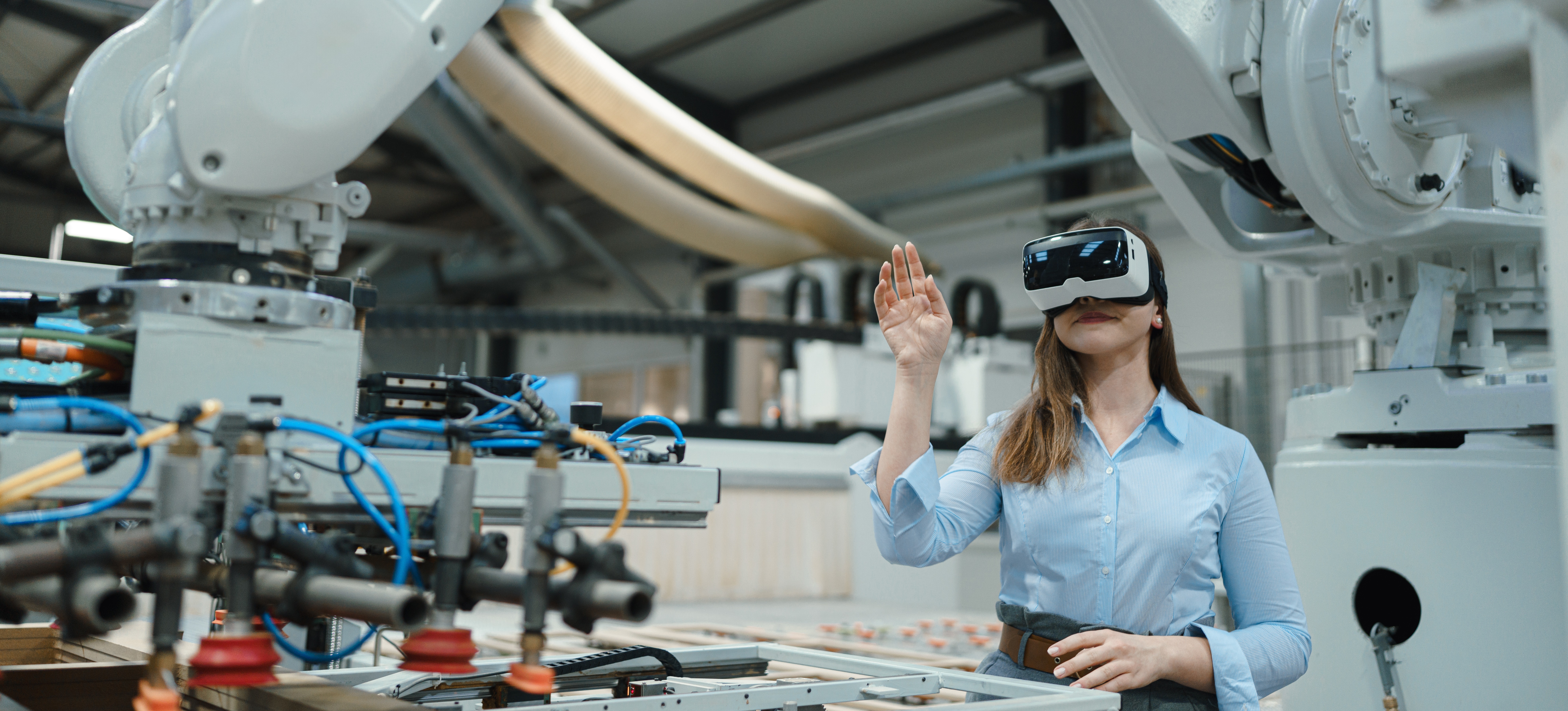 [Featured Image] A woman is wearing a VR headset while discovering robotics as an artificial intelligence career path.