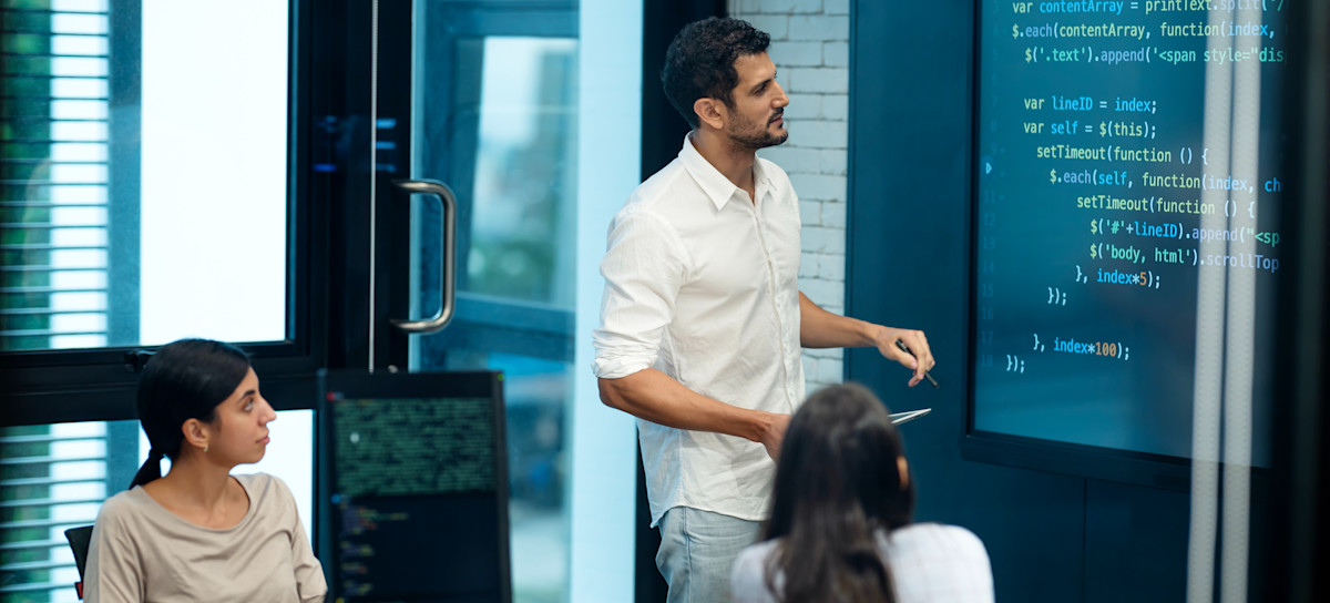 [Featured Image] An information security manager leads a meeting to highlight the company’s current cybersecurity measures and discuss strategies for detecting vulnerabilities and responding to incidents.
